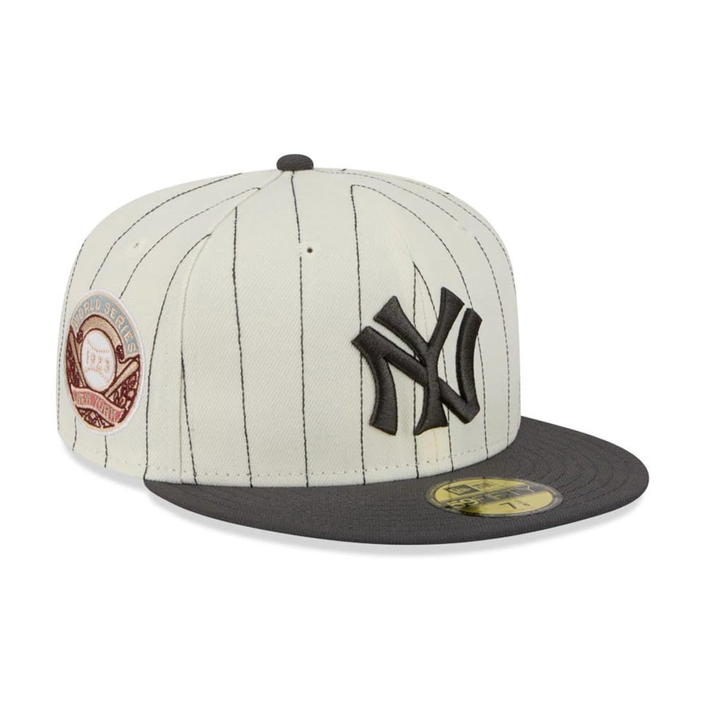 New York Yankees MLB Stripes Cream & Black New Era 59FIFTY Fitted Cap, three-quarter view showing raised black NY logo embroidery on the front panel, grey visor with gold 59FIFTY size sticker, and World Series patch on the side.