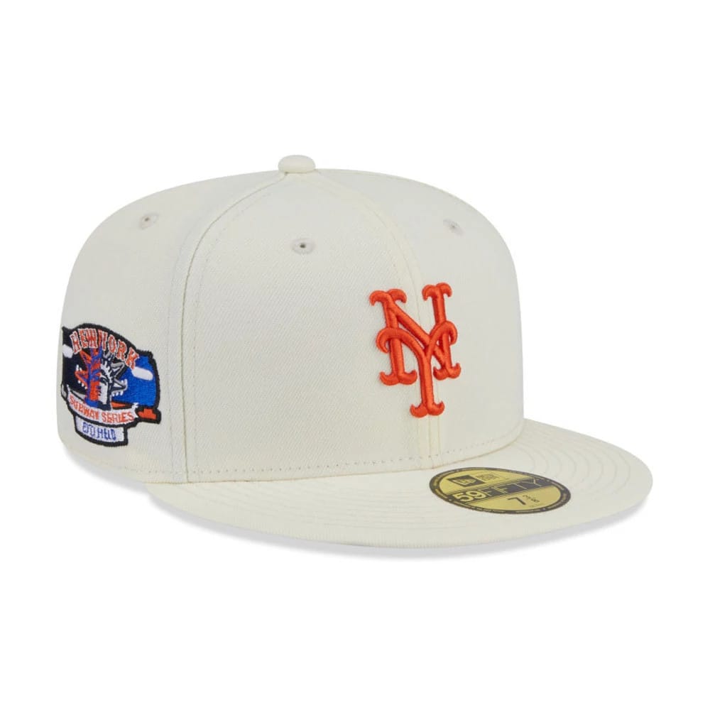 New York Mets MLB City Series White New Era 59FIFTY Fitted Cap, three-quarter view showing the orange embroidered NY logo on the front panel, gold 59FIFTY size sticker on the flat visor, and a commemorative patch on the left side.