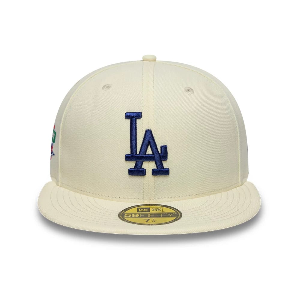 LA Dodgers MLB City Series White New Era 59FIFTY Fitted Cap, front view featuring raised blue LA embroidery on the front panel with a flat visor, gold 59FIFTY size sticker, and left side patch.