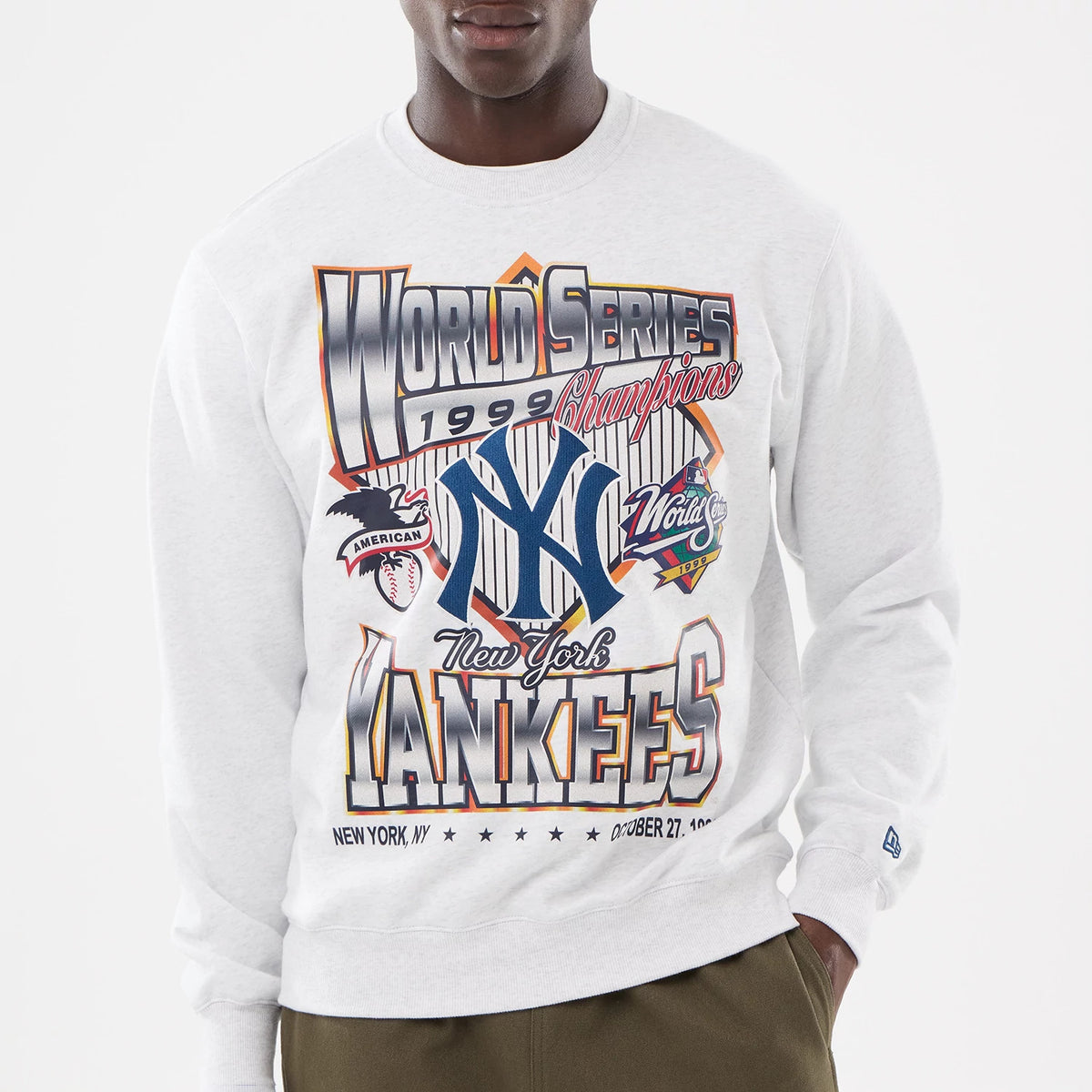 New York Yankees MLB Retro White Oversized Crew Neck Sweater, front view on a model with bold World Series 1999 Champions graphics featuring the New York Yankees logo, embroidered New Era flag logo on the sleeve.