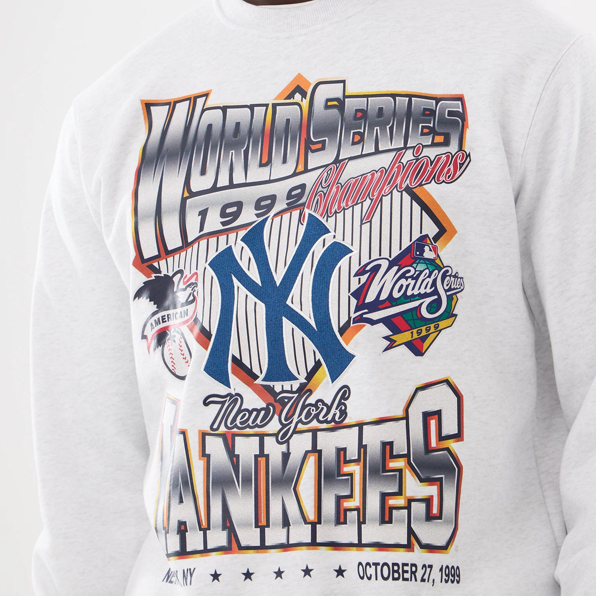 New York Yankees MLB Retro White Oversized Crew Neck Sweater, front view on a model showing bold 1999 World Series Champions graphics across the chest with prominent blue New York Yankees logo and vibrant text accents.