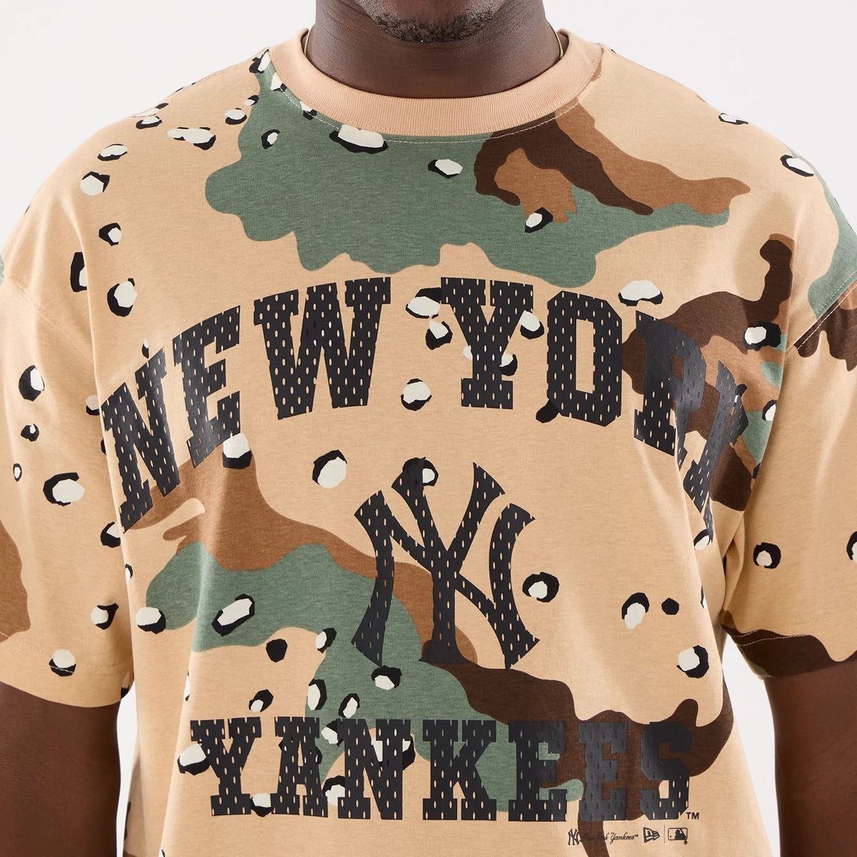 New York Yankees MLB Camo Desert Camo T-Shirt, front view showing the bold black lettering of "New York Yankees" across the chest, a large black New York Yankees logo below it, and a mix of green and brown camo pattern all over the shirt.
