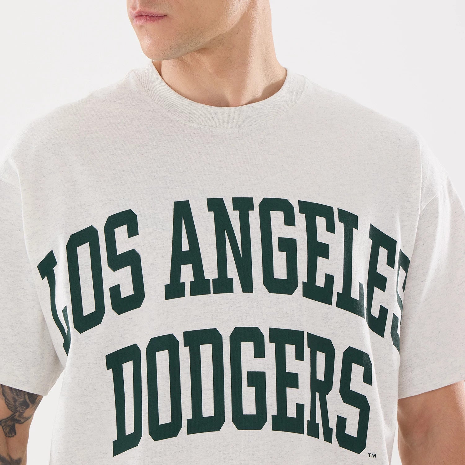 New Era LA Dodgers MLB Comfort Grey T-Shirt, front view featuring bold black Los Angeles Dodgers text across the chest on a light grey background, with a ribbed neckline at the top.