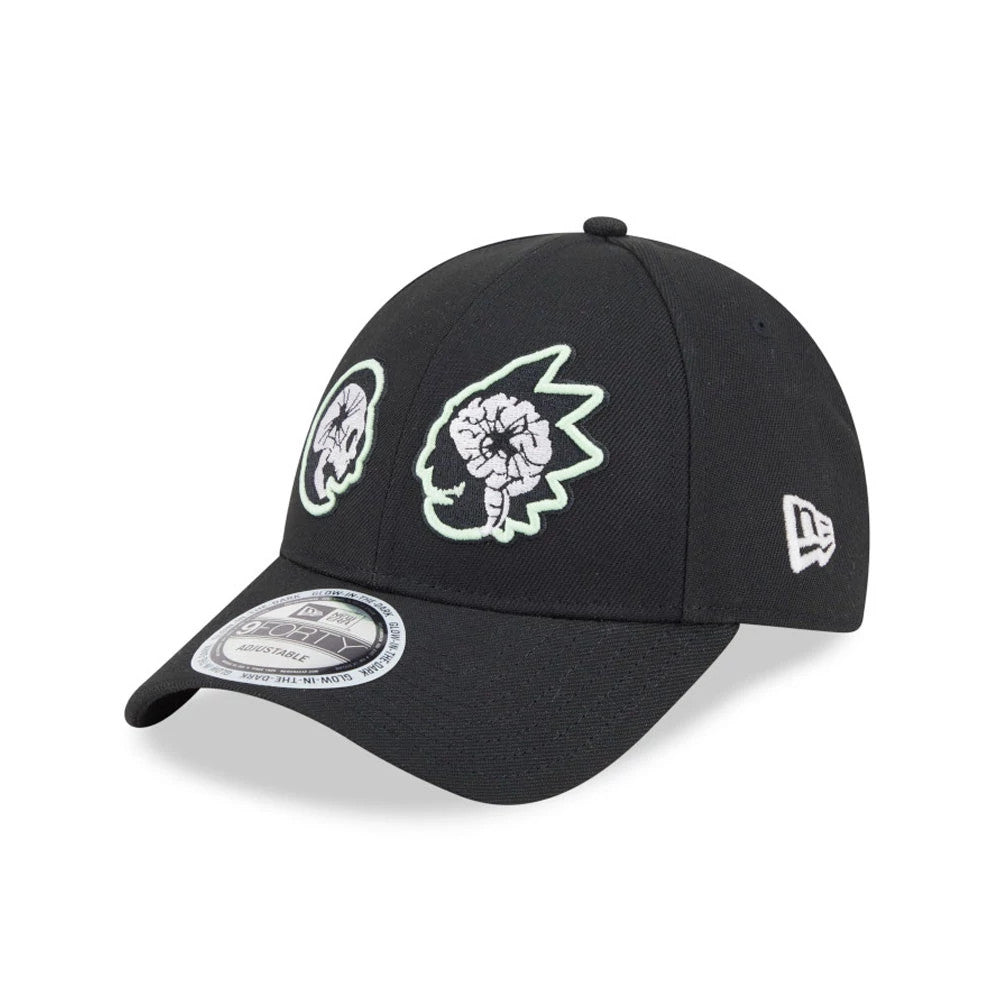 Rick And Morty Glow In The Dark Black New Era 9FORTY Adjustable Cap, three-quarter view showing glow-in-the-dark character embroidery on the front panel, a curved visor with a 9FORTY size sticker, and the New Era flag logo on the left side.