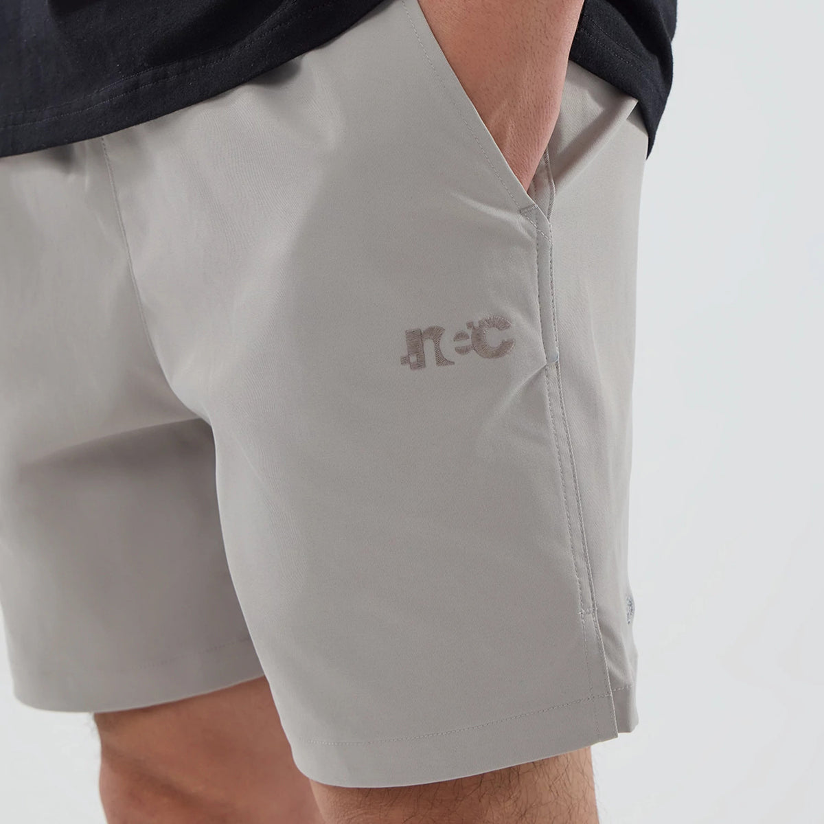 The model is wearing this New Era NEC Logo Oversized Shorts in Beige . 2