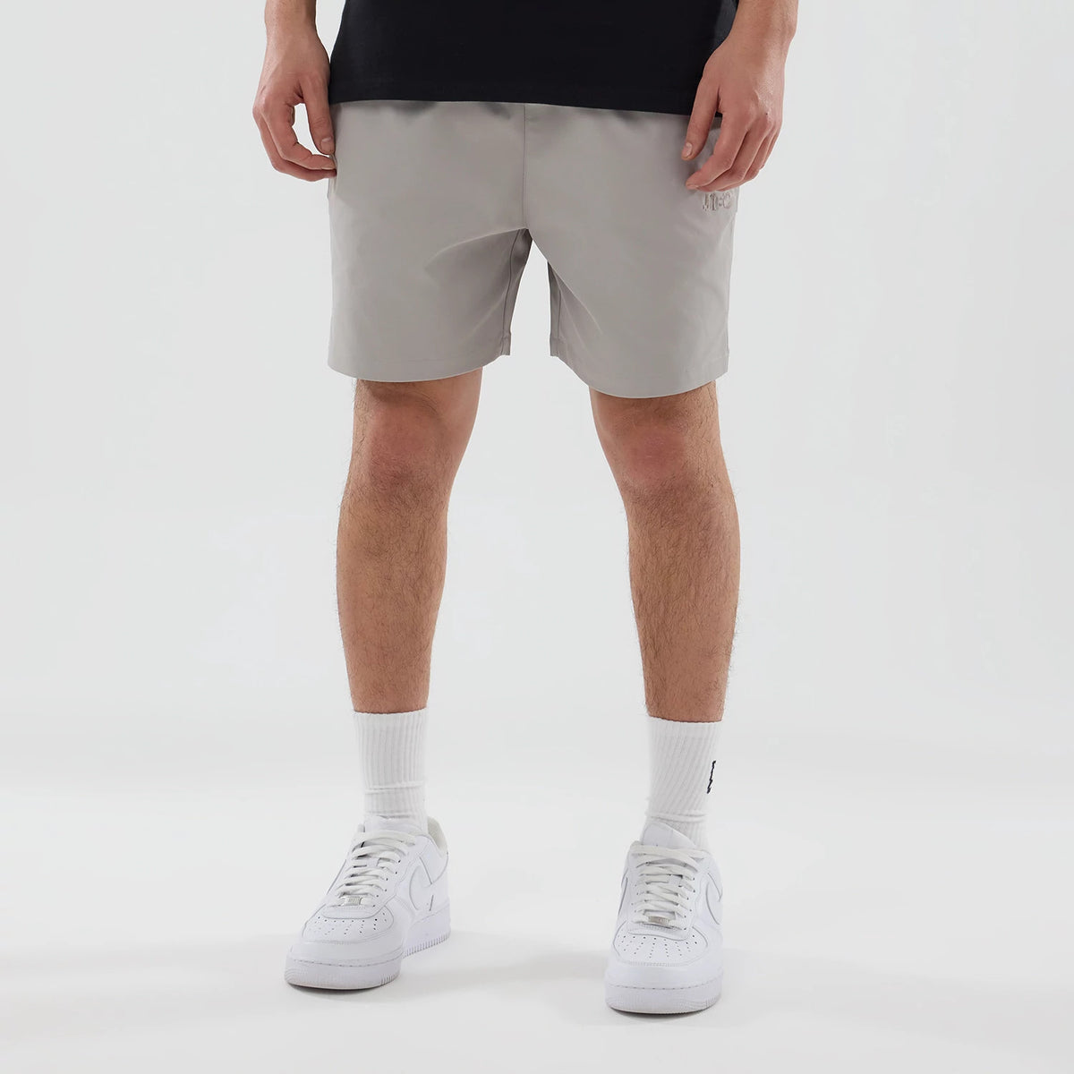 The model is wearing this New Era NEC Logo Oversized Shorts in Beige . 1