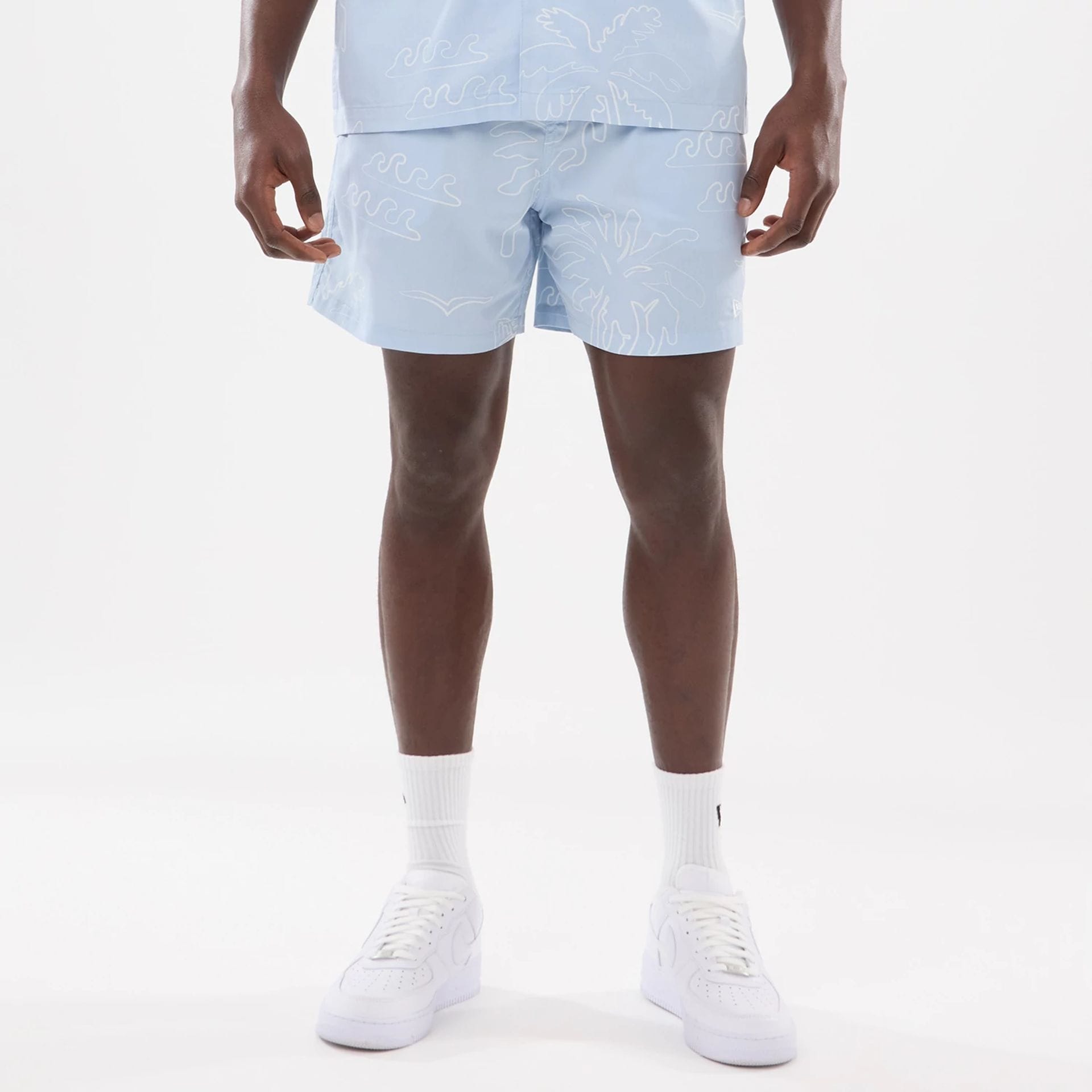 The model is wearing these New Era Resort Oversized Shorts in blue. 1