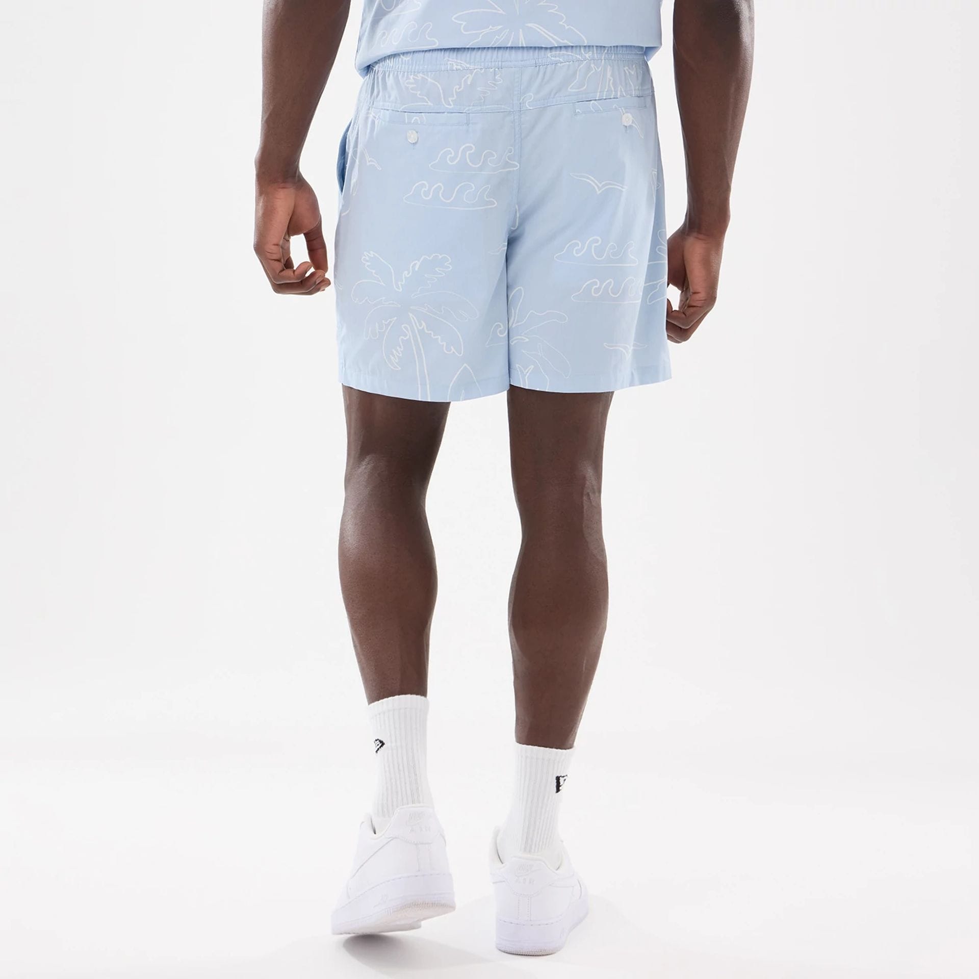 The model is wearing these New Era Resort Oversized Shorts in blue. 2