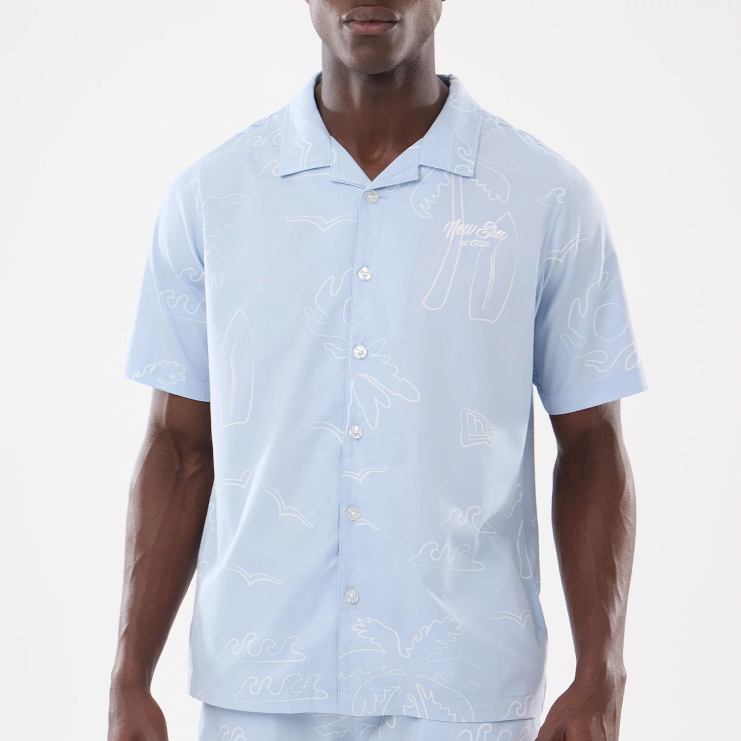 The model is wearing this New Era Resort Short Sleeve Shirt in blue. 3