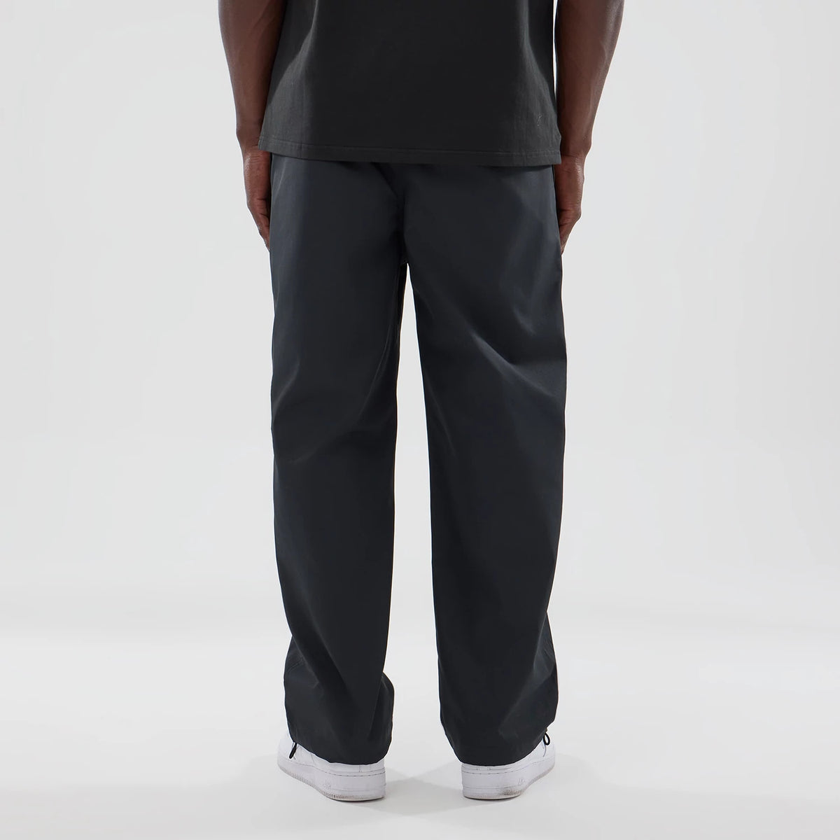 The model is wearing this New Era NEC Logo Straight Leg Joggers in black. 2