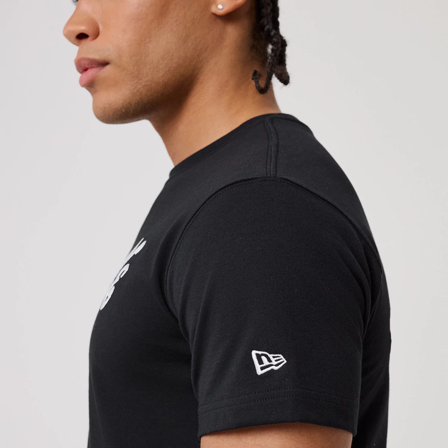 The model is wearing this New Era Sakura T-Shirt in black. 7