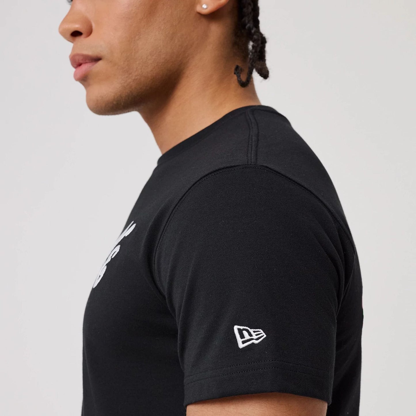 The model is wearing this New Era Sakura T-Shirt in black. 7