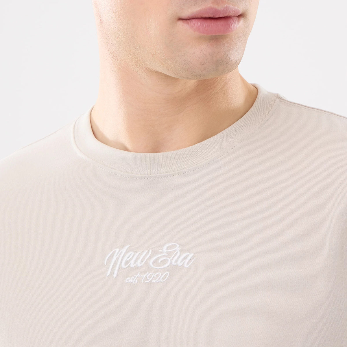 The model is wearing this New Era Resort T-Shirt in natural. 3