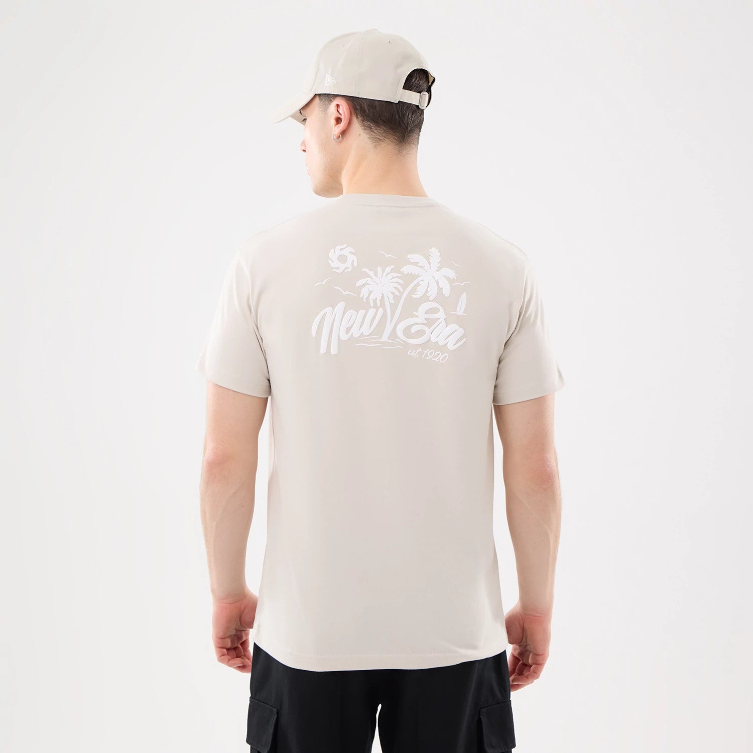 The model is wearing this New Era Resort T-Shirt in natural. 2