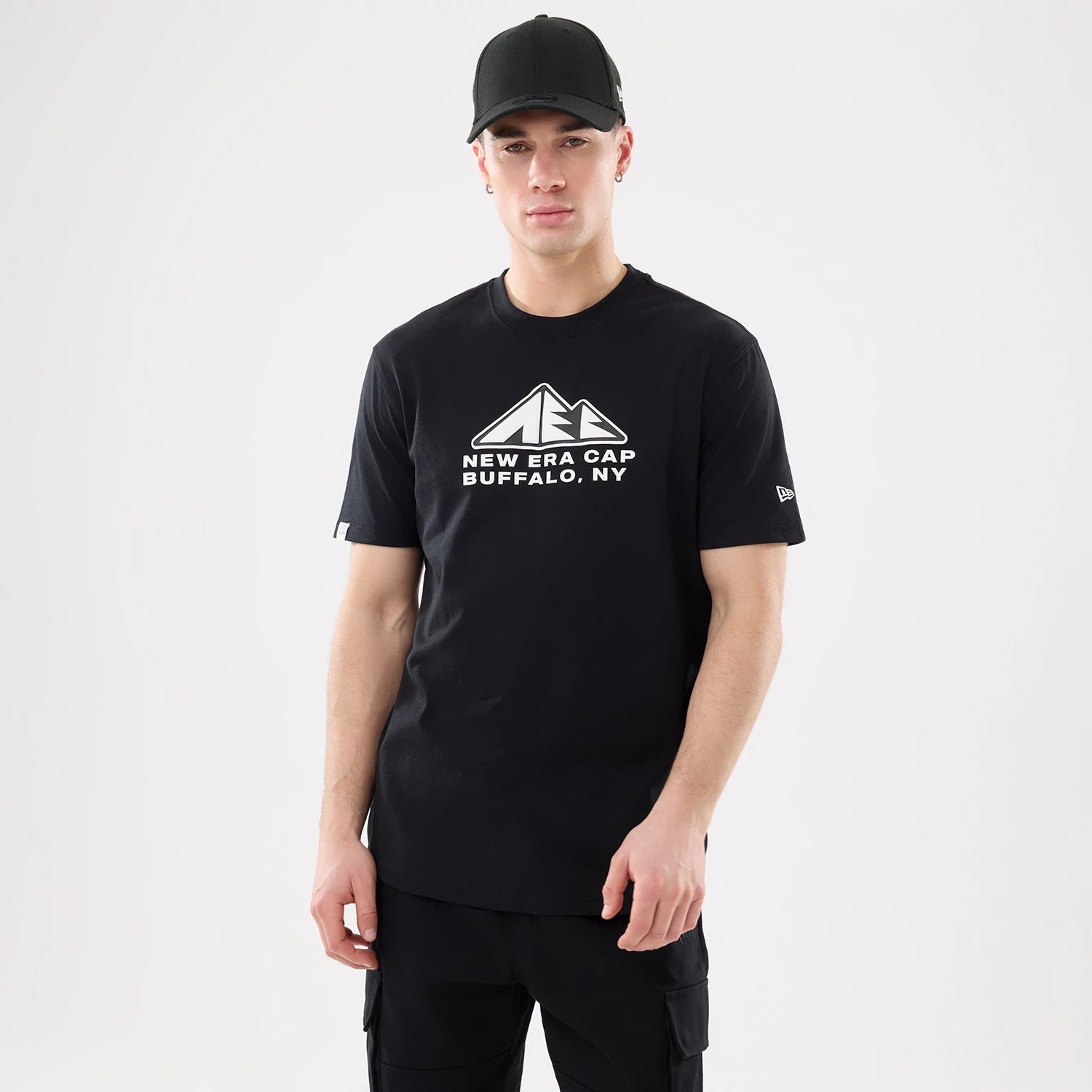 The model is wearing this New Era Outdoor Mountain T-Shirt in black. 1