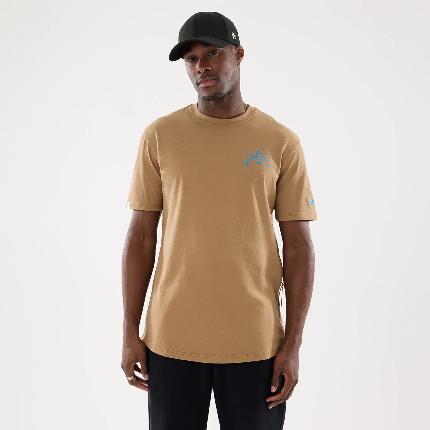 The model is wearing this New Era Outdoor Fishing T-Shirt in Beige. 1