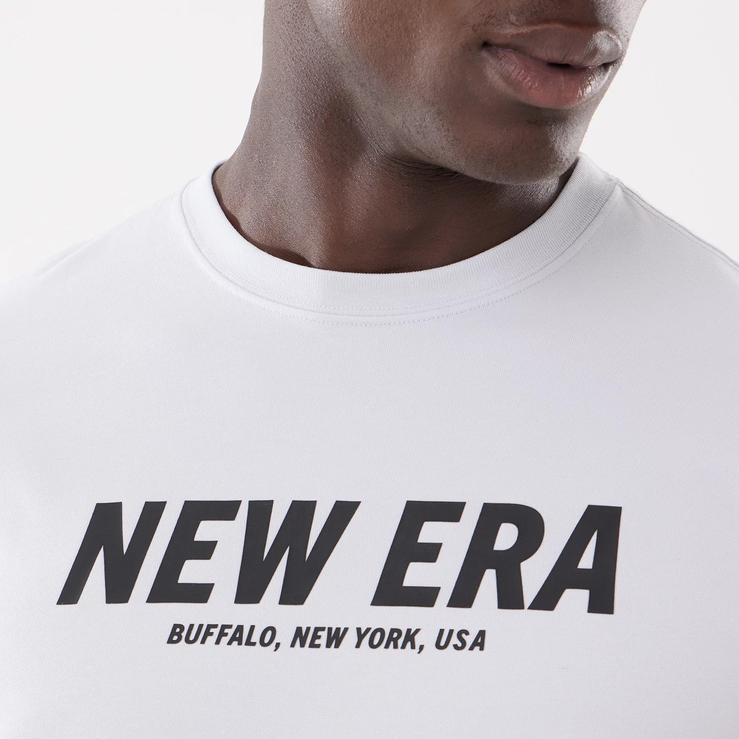 The model is wearing this New Era Basic T-Shirt in white. 3