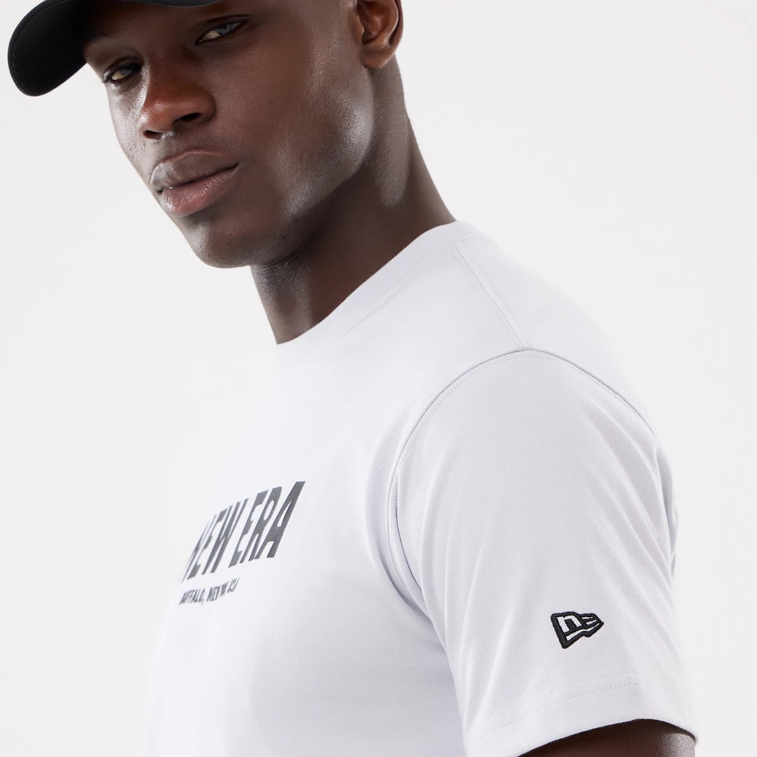 The model is wearing this New Era Basic T-Shirt in white. 4