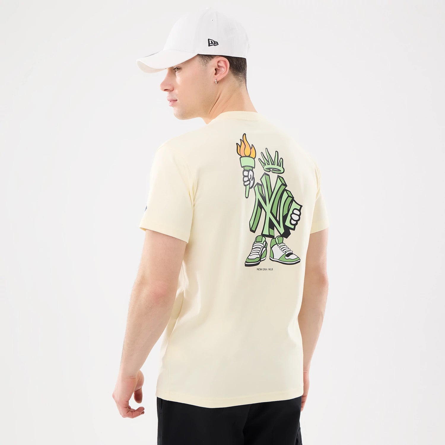 The model is wearing this MLB Cartoon New York Yankees T-Shirt in cream. 2