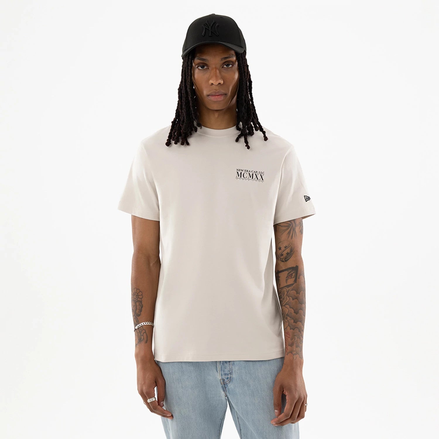The model is wearing this New Era Heritage T-Shirt in Cream. 1