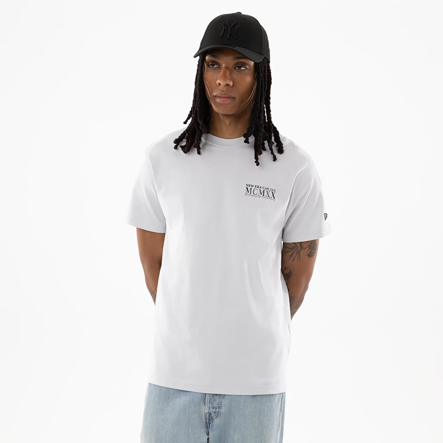 The model is wearing this New Era Heritage T-Shirt in White. 1