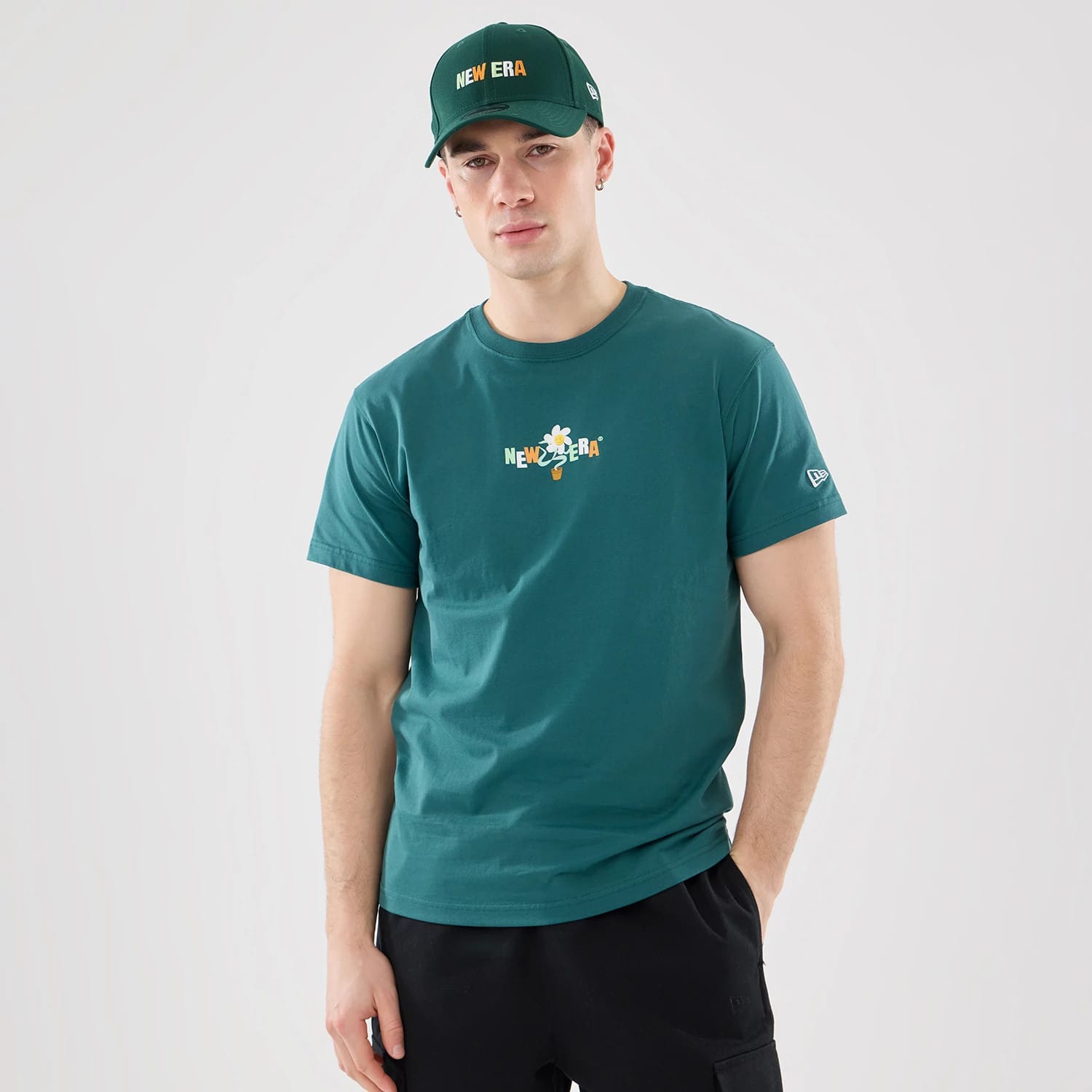 The model is wearing this New Era Earth Day T-Shirt in dark green. 1