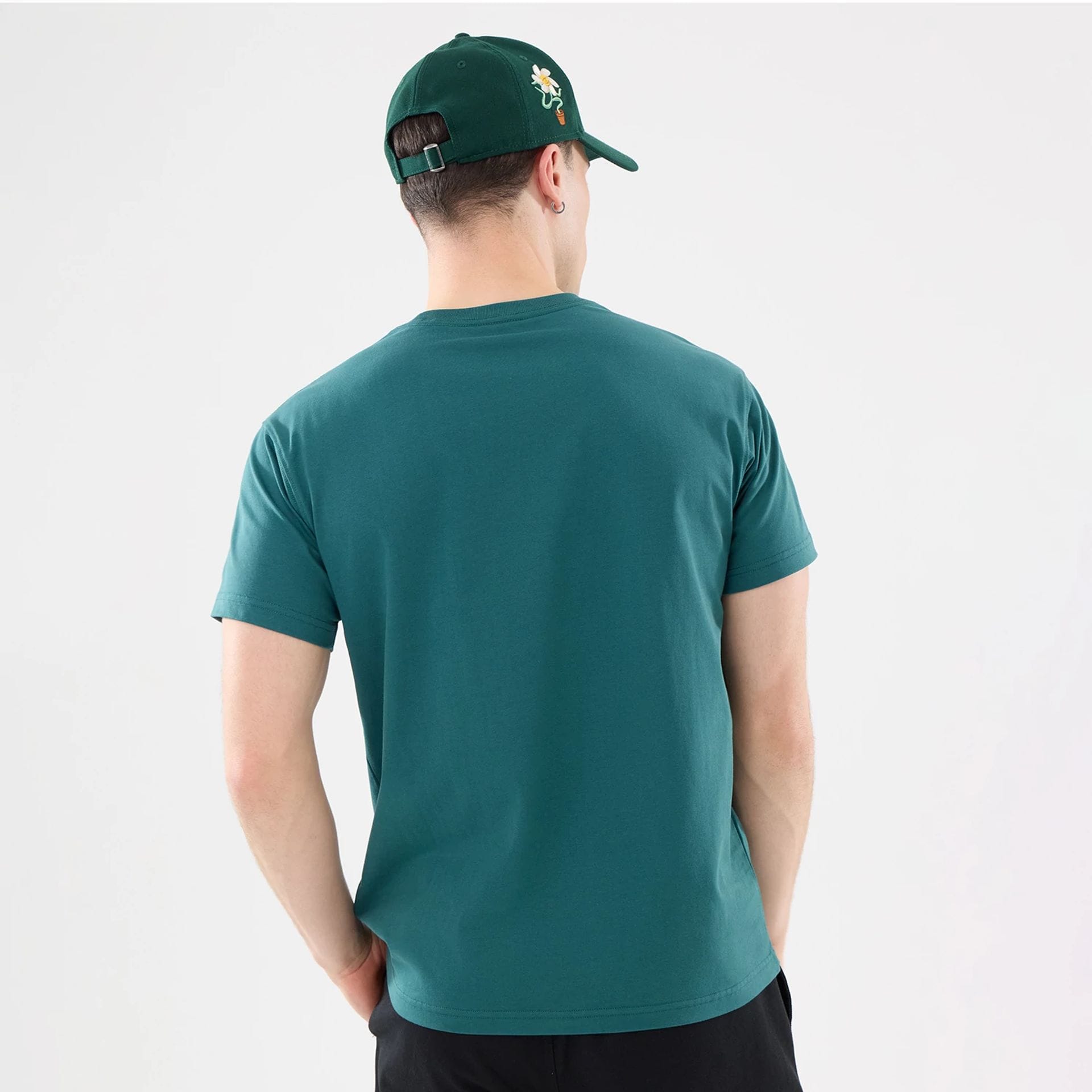 The model is wearing this New Era Earth Day T-Shirt in dark green. 2