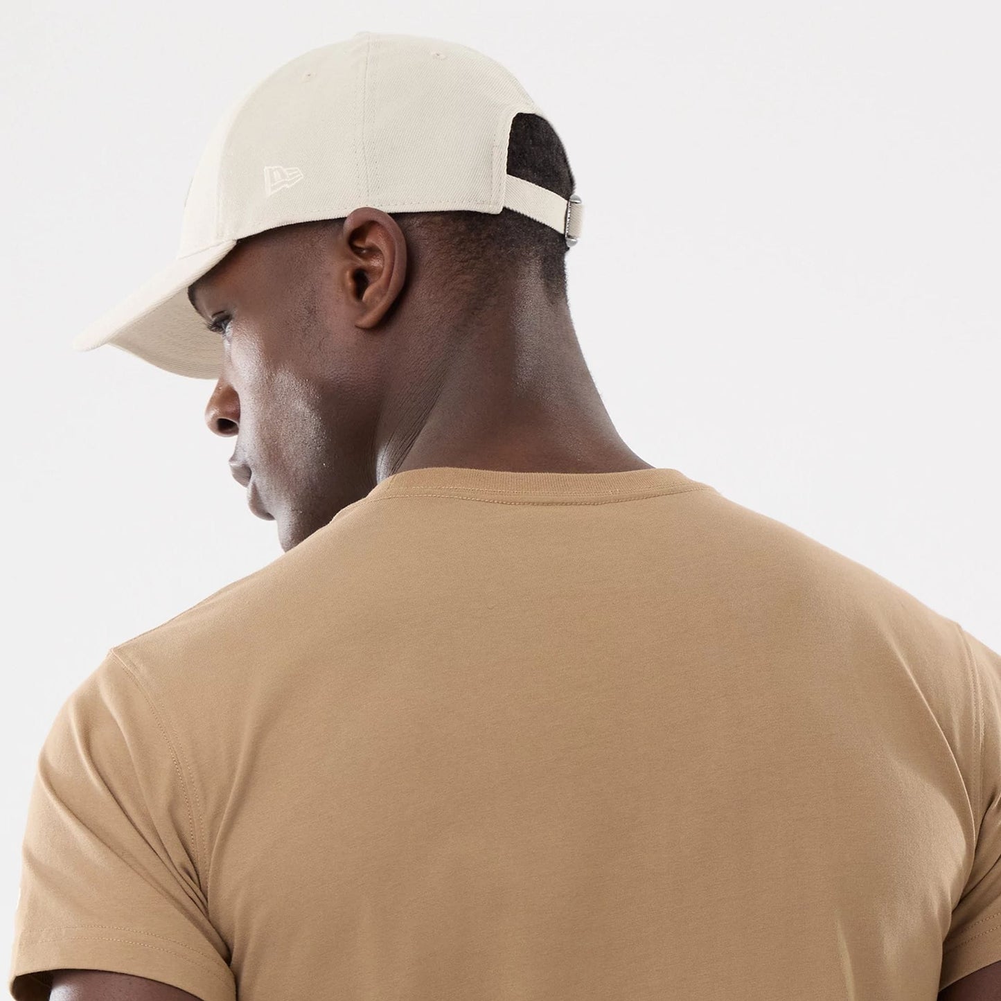 The model is wearing this New Era Earth Day T-Shirt in beige/khaki. 7