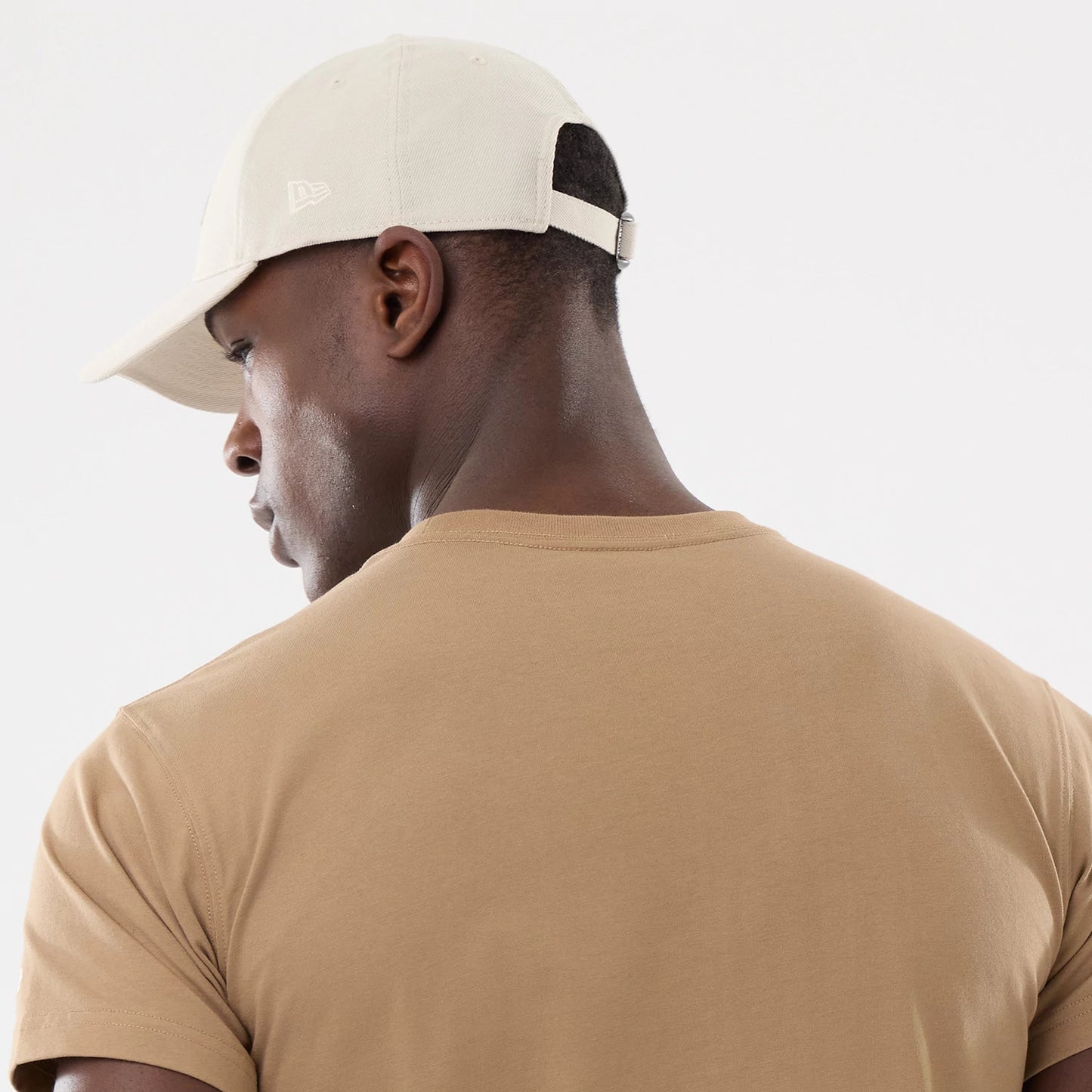 The model is wearing this New Era Earth Day T-Shirt in beige/khaki. 7