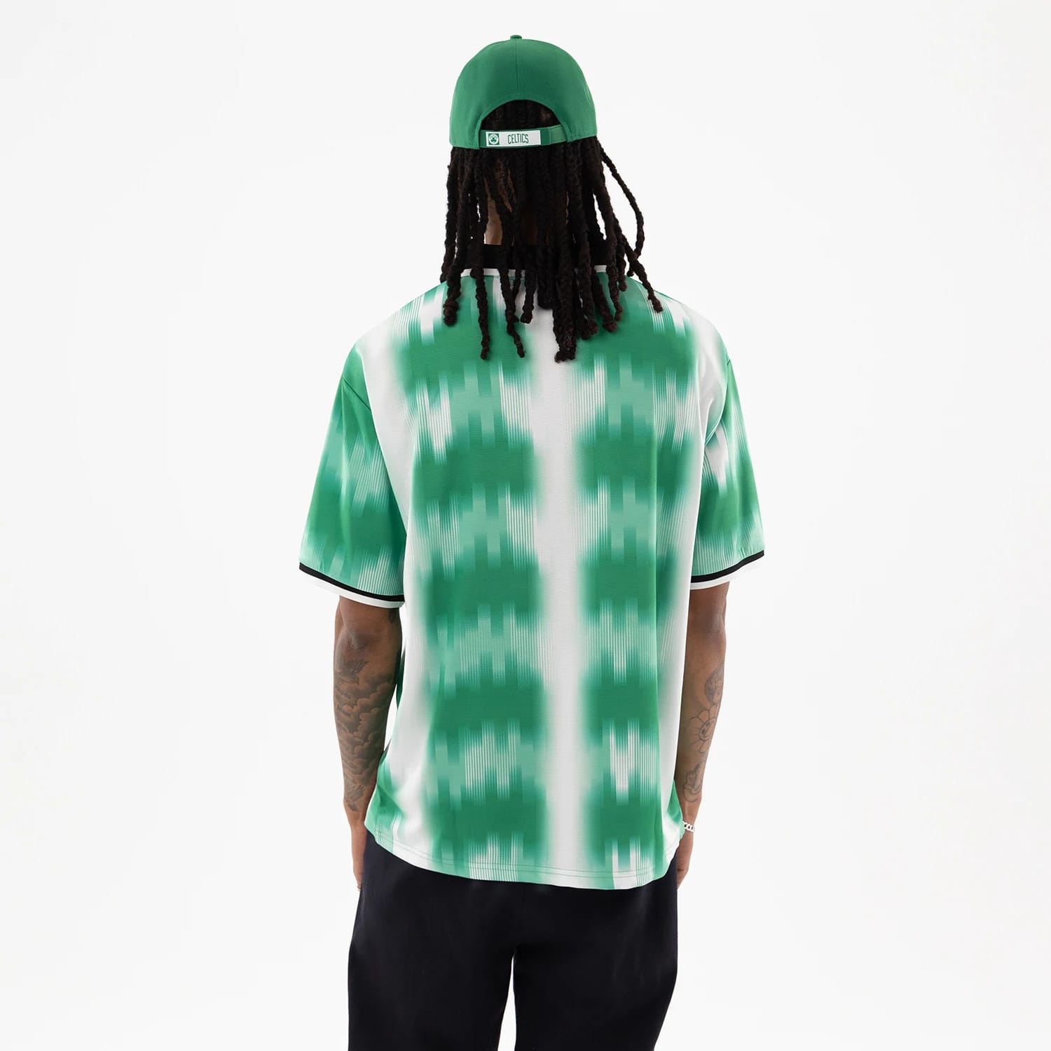 The model is wearing this NBA Boston Celtics Soccer Jersey in green. 2