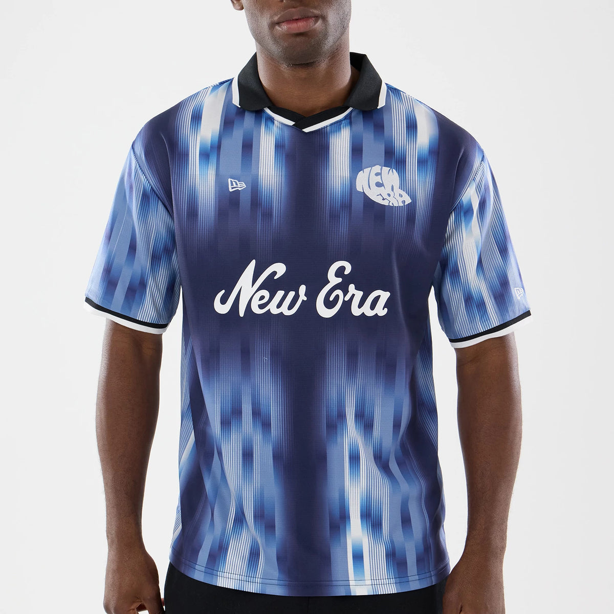 New Era Navy Soccer Jersey, front view on a model showing the white New Era script logo across the chest, a black collar with white trim, blue vertical stripes, and a New Era flag logo embroidered on the left chest.