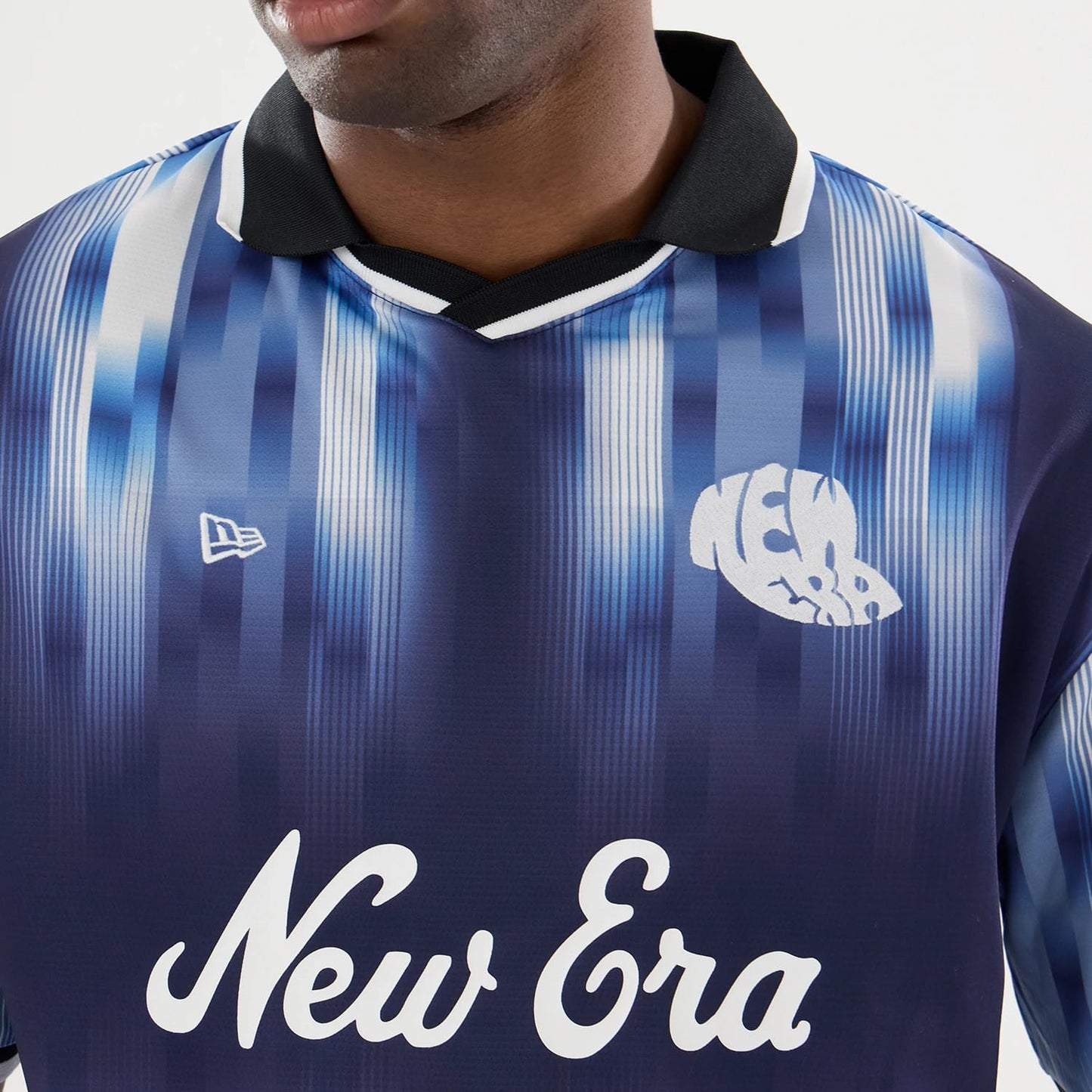 The model is wearing this New Era Soccer Jersey in navy. 7