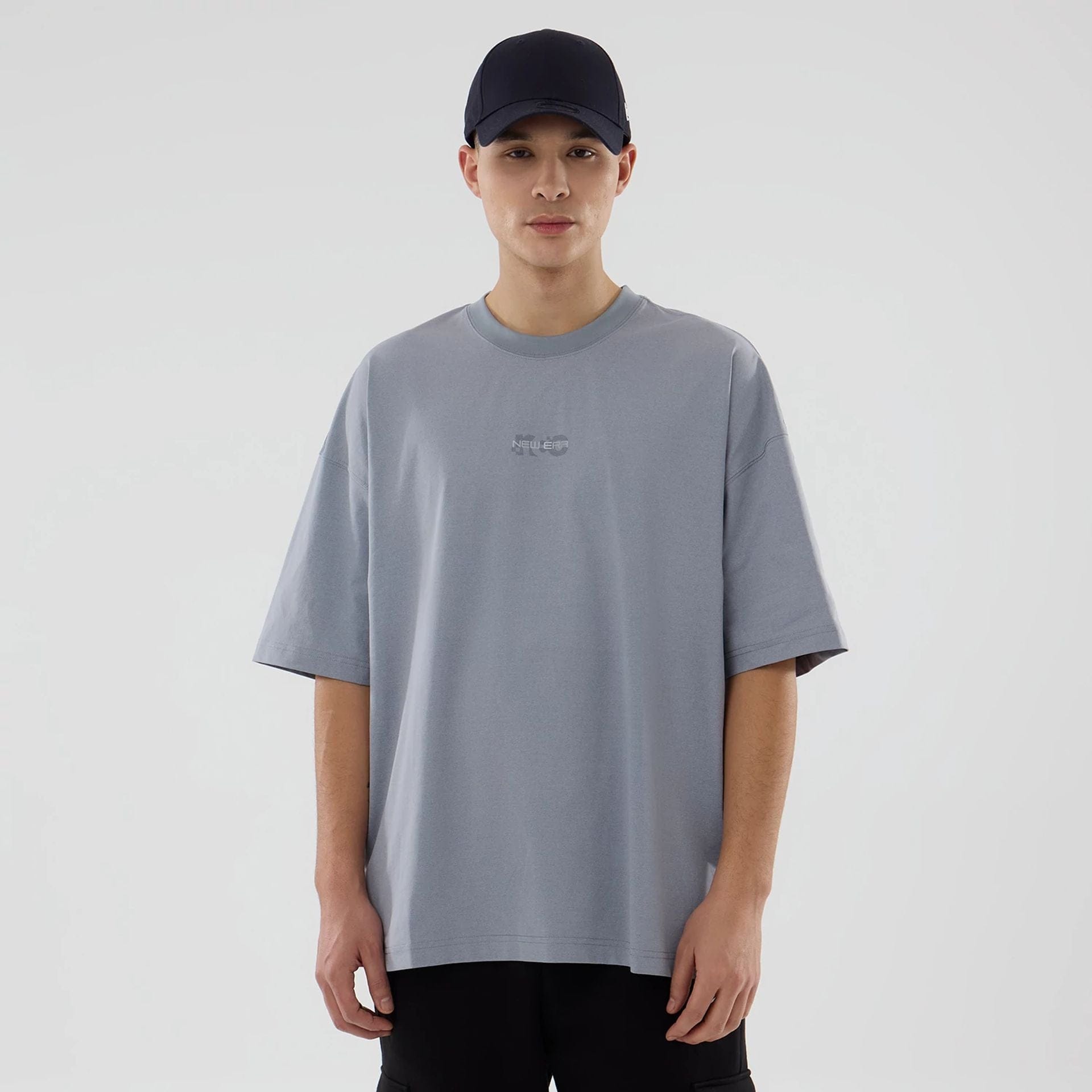The model is wearing this New Era Urban Core Oversized T-Shirt in grey. 1