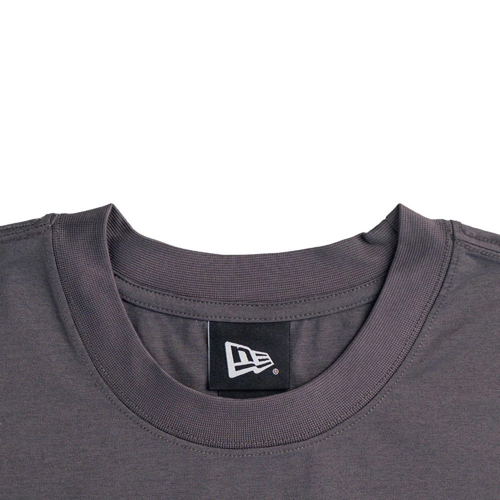 New Era NEC Logo Black Oversized T-Shirt, front view showing the neckline with a debossed New Era logo on a black tag situated inside the collar, accentuating the simple and classic round-neck design.