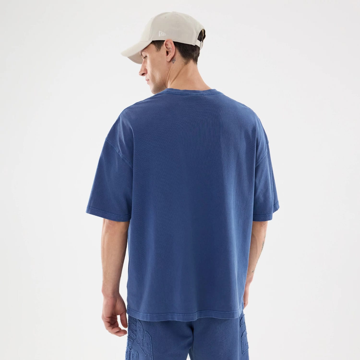 The model is wearing this New Era Street Archived Oversized T-Shirt in blue. 2