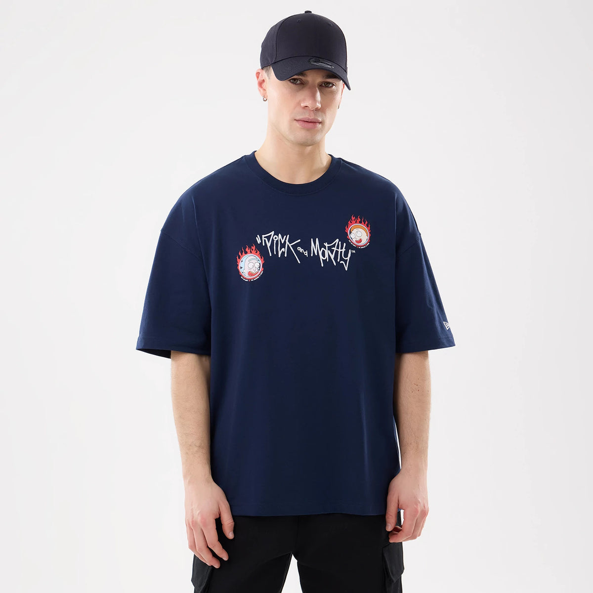 Rick And Morty Blue T-Shirt, front view showing a relaxed fit with Rick and Morty logo in white across the chest and two flame-encircled character graphics, worn by a person in a black cap with a debossed logo on the peak.