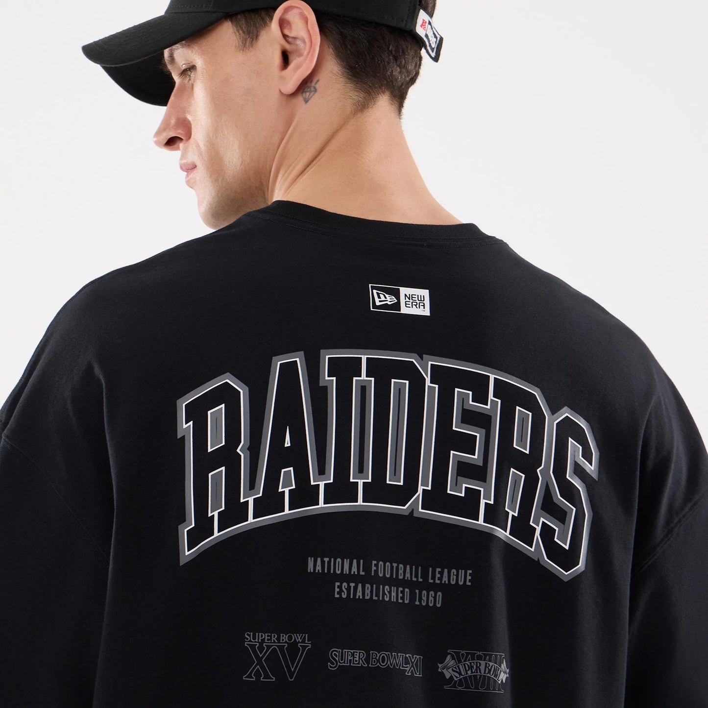 The model is wearing this NFL Raiders Wear Las Vegas Raiders Oversized T-Shirt in black. 7