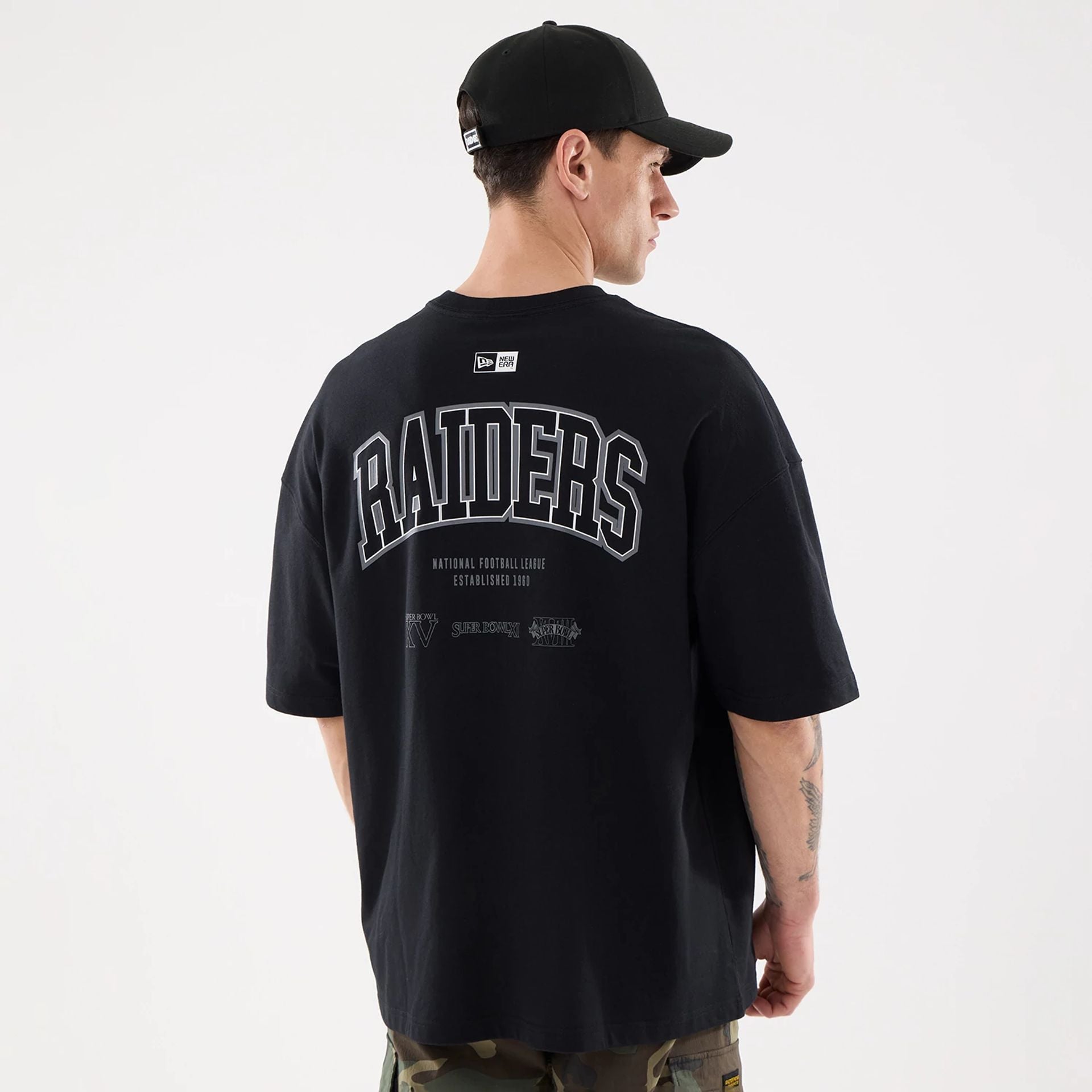 The model is wearing this NFL Raiders Wear Las Vegas Raiders Oversized T-Shirt in black. 2