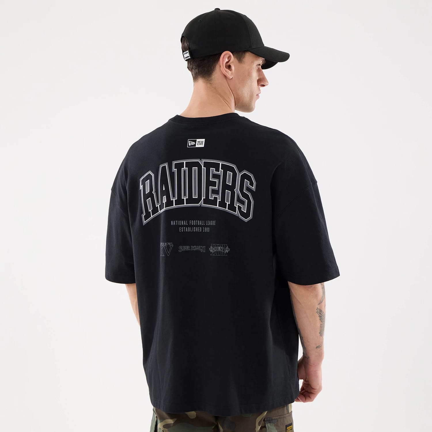 The model is wearing this NFL Raiders Wear Las Vegas Raiders Oversized T-Shirt in black. 2