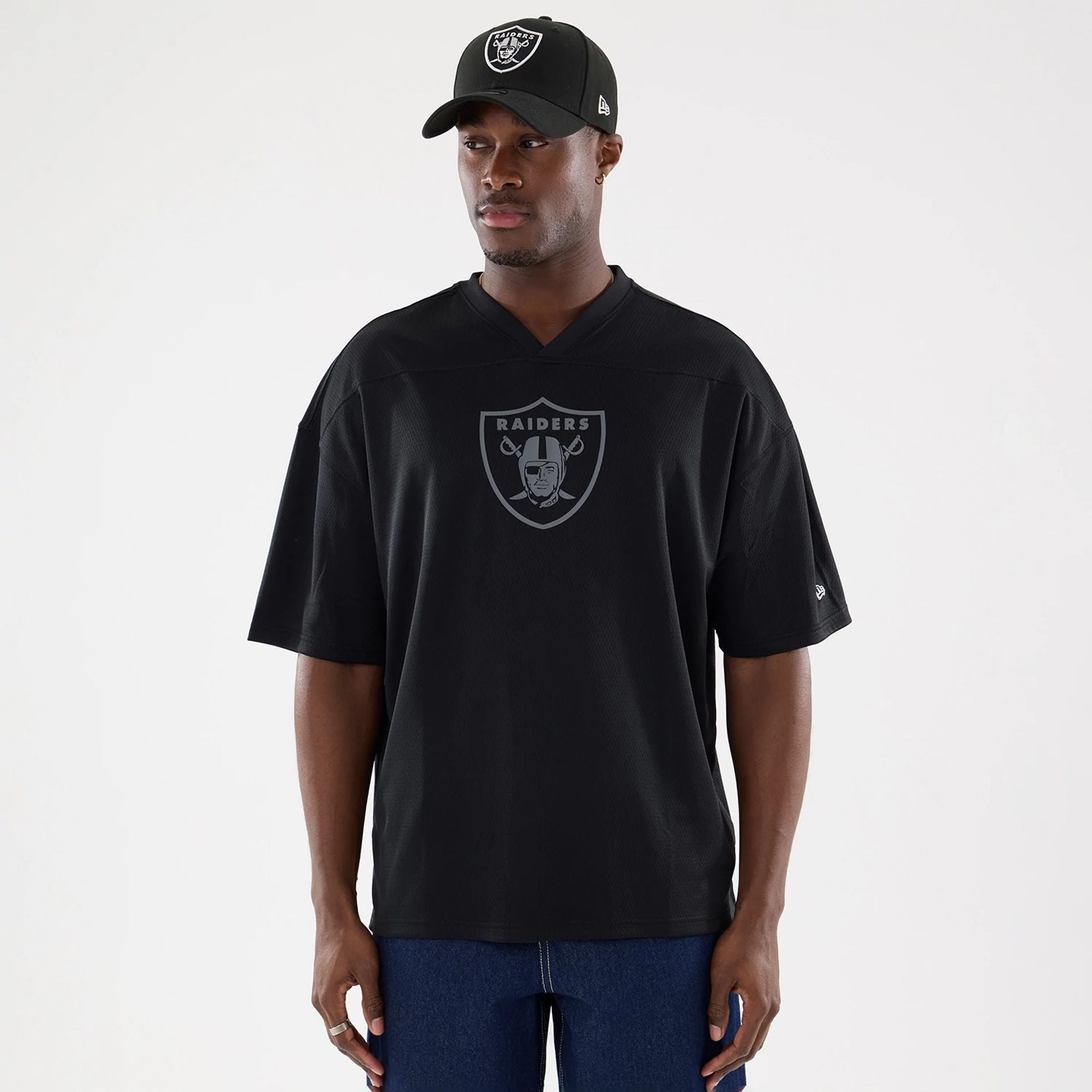 The model is wearing this NFL Raiders Wear Black Las Vegas Raiders Mesh Oversized T-Shirt in black. 1