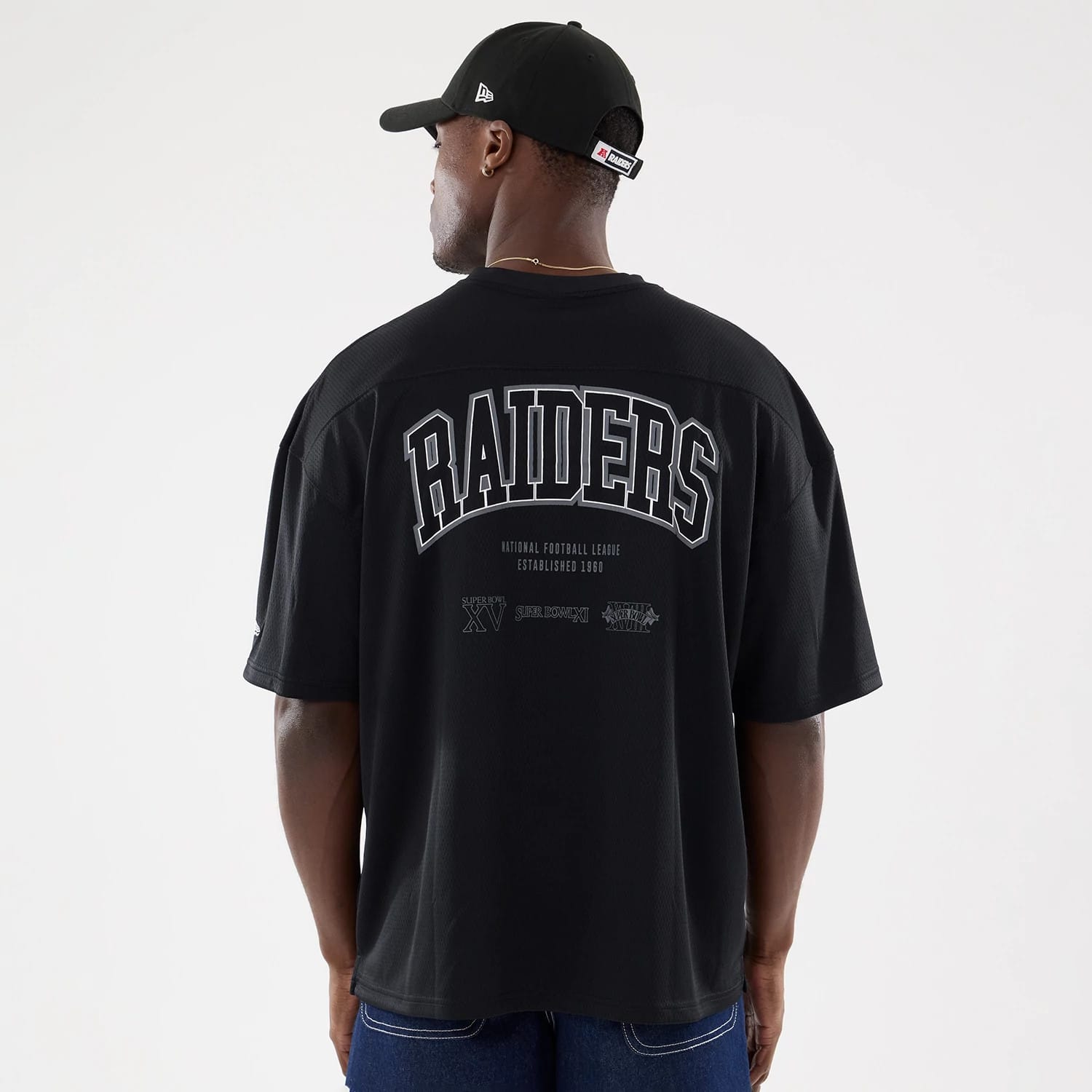 The model is wearing this NFL Raiders Wear Black Las Vegas Raiders Mesh Oversized T-Shirt in black. 2