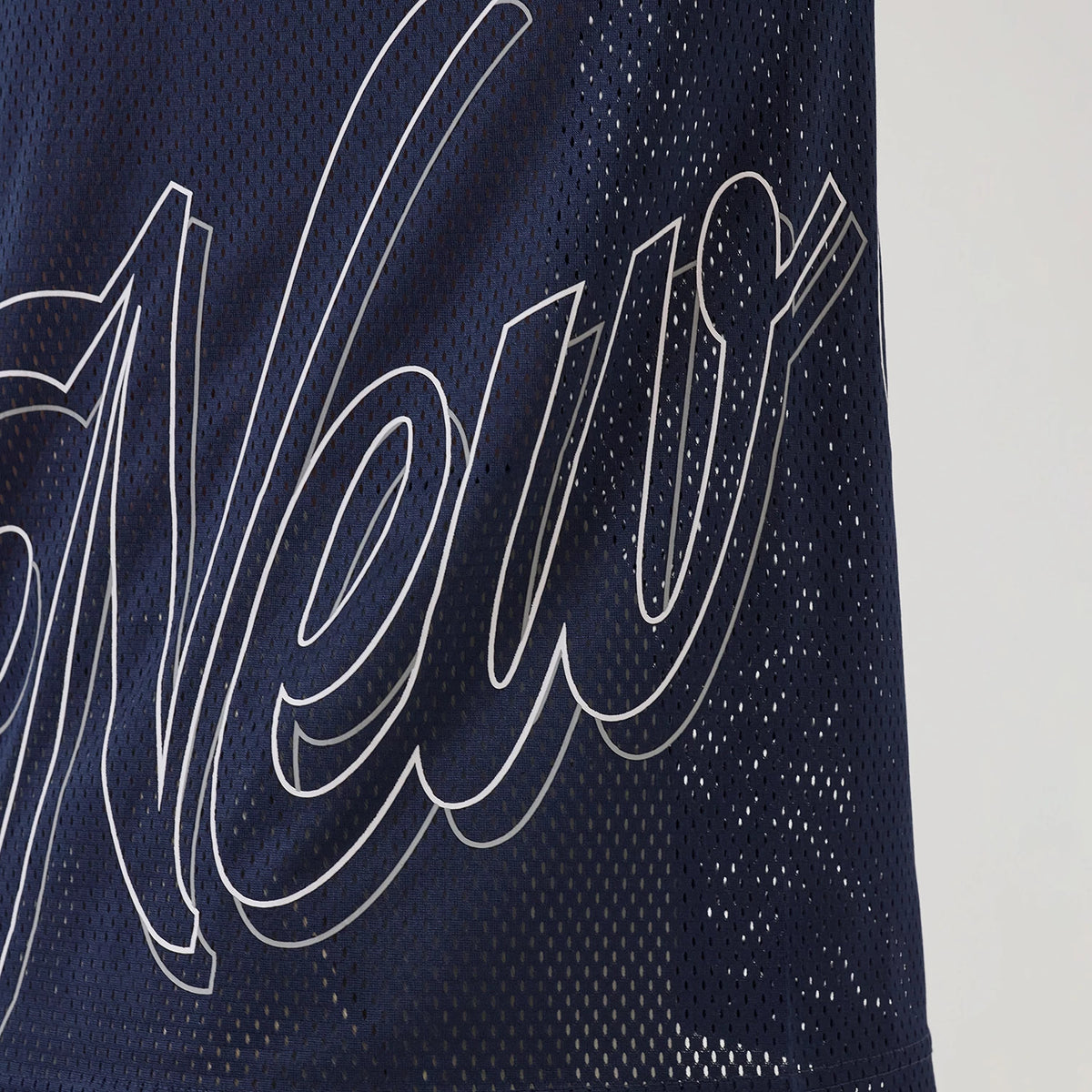 New Era Mix League Blue Oversized Mesh T-Shirt, front view showing the intricately outlined "New" lettering across the perforated blue mesh surface with small eyelets uniformly distributed throughout.
