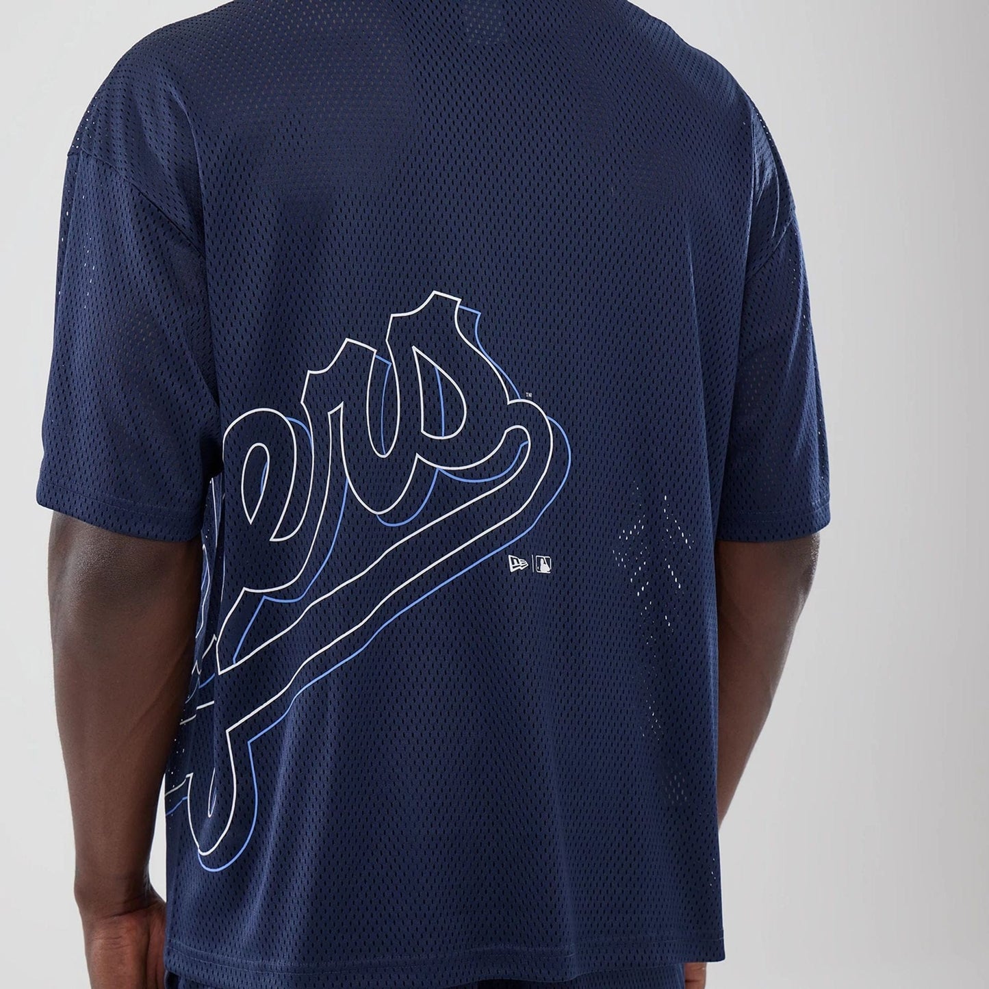 The model is wearing this MLB Mix League LA Dodgers Oversized Mesh T-Shirt in blue. 7