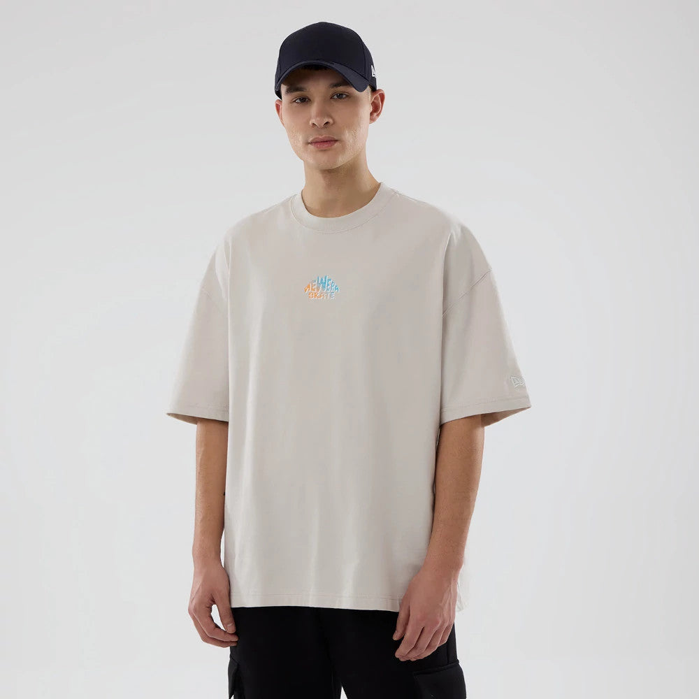 The model is wearing this New Era Skate Is Life Graphic Oversized T-Shirt in Cream. 7