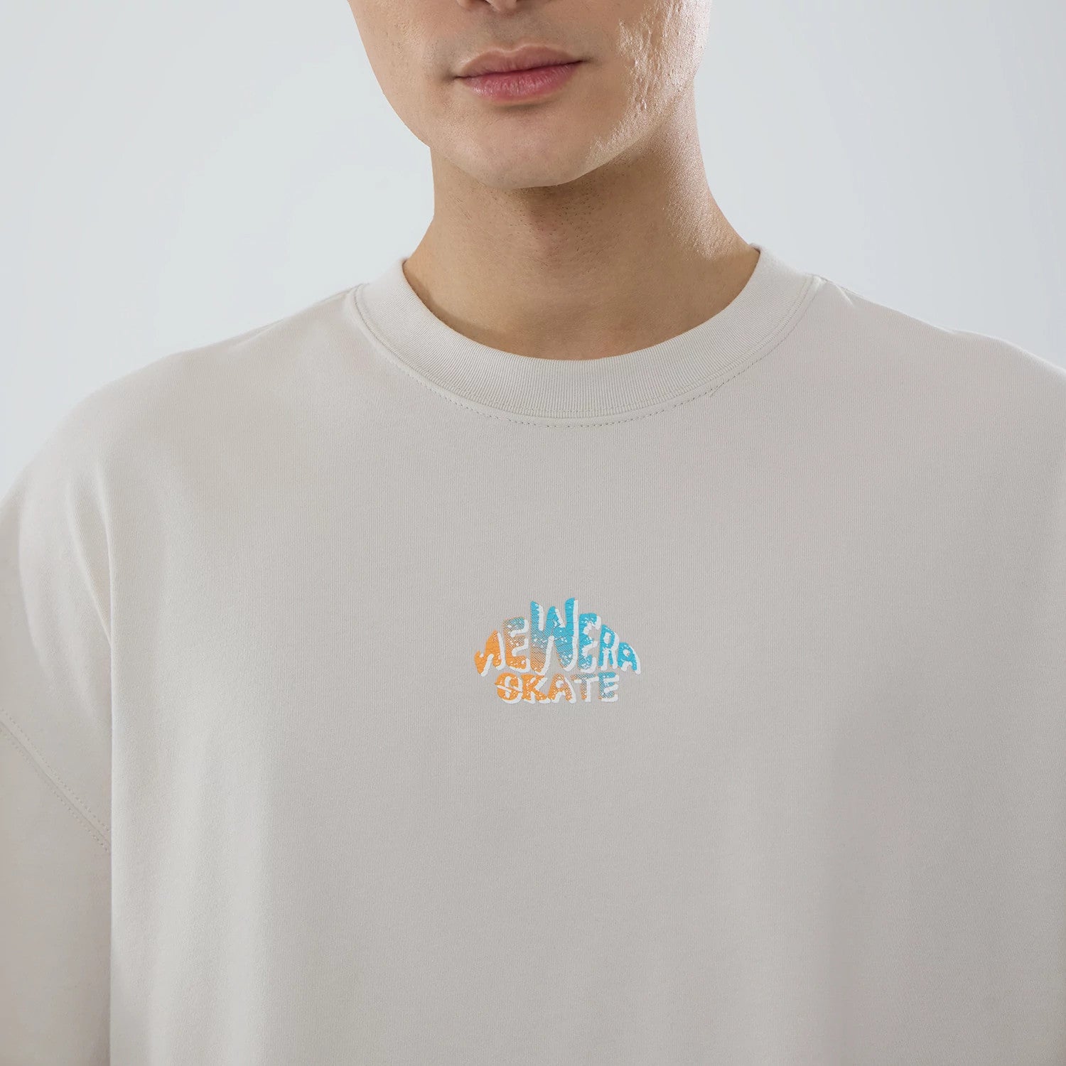 The model is wearing this New Era Skate Is Life Graphic Oversized T-Shirt in Cream. 3