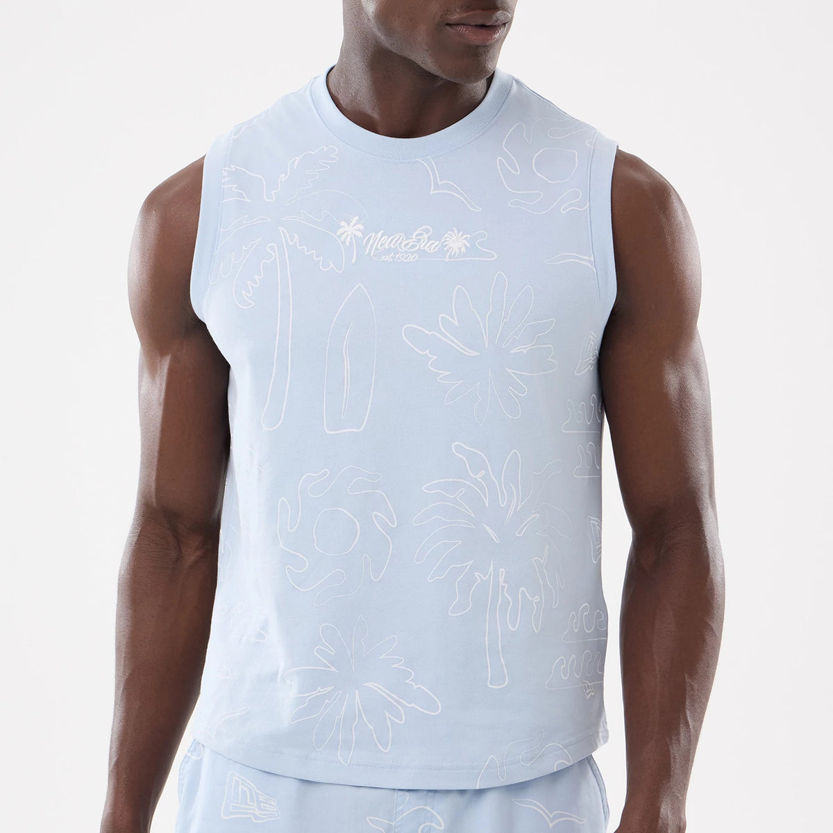 New Era Resort Blue Tank Top, front view on a model wearing matching shorts, showcasing white embroidered palm tree and wave graphics across the chest, with the New Era logo integrated in the design.