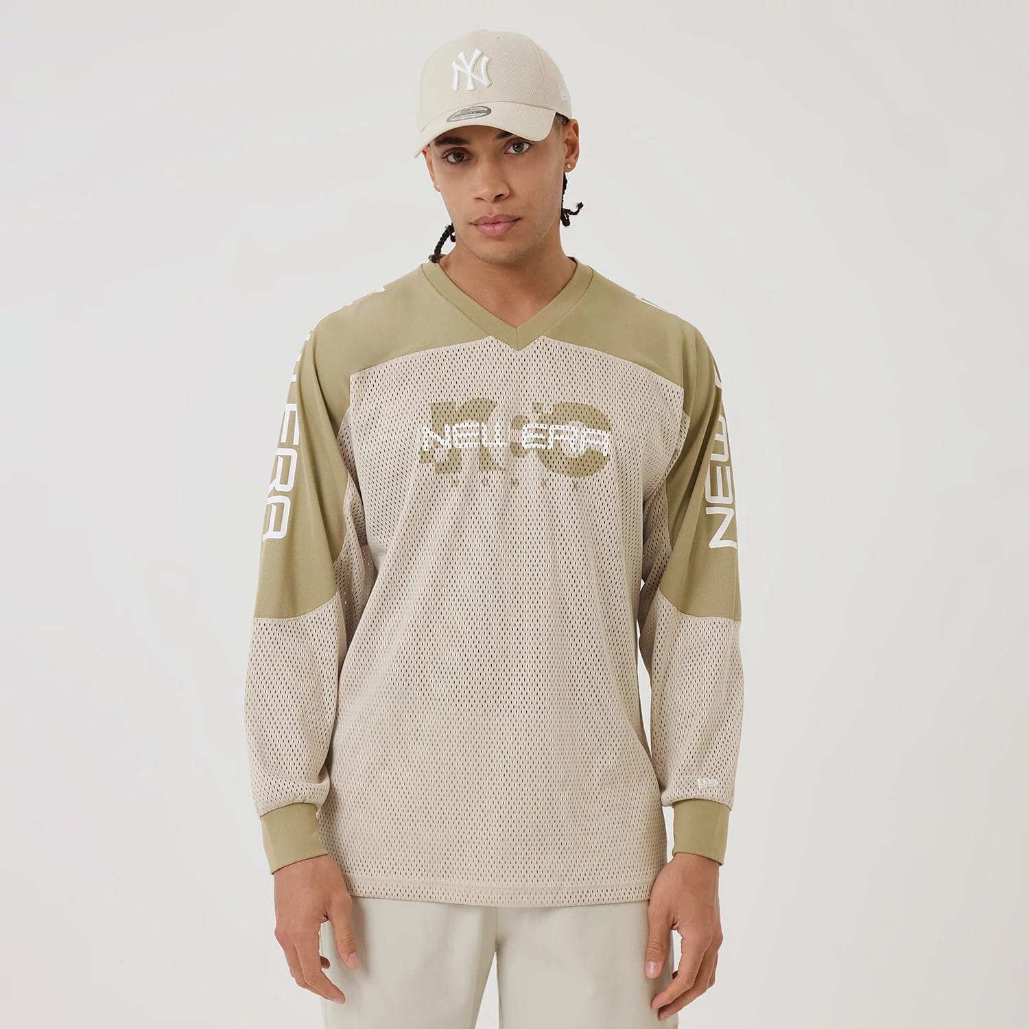 The model is wearing this New Era NEC Logo Long Sleeve Jersey in beige/khaki. 1