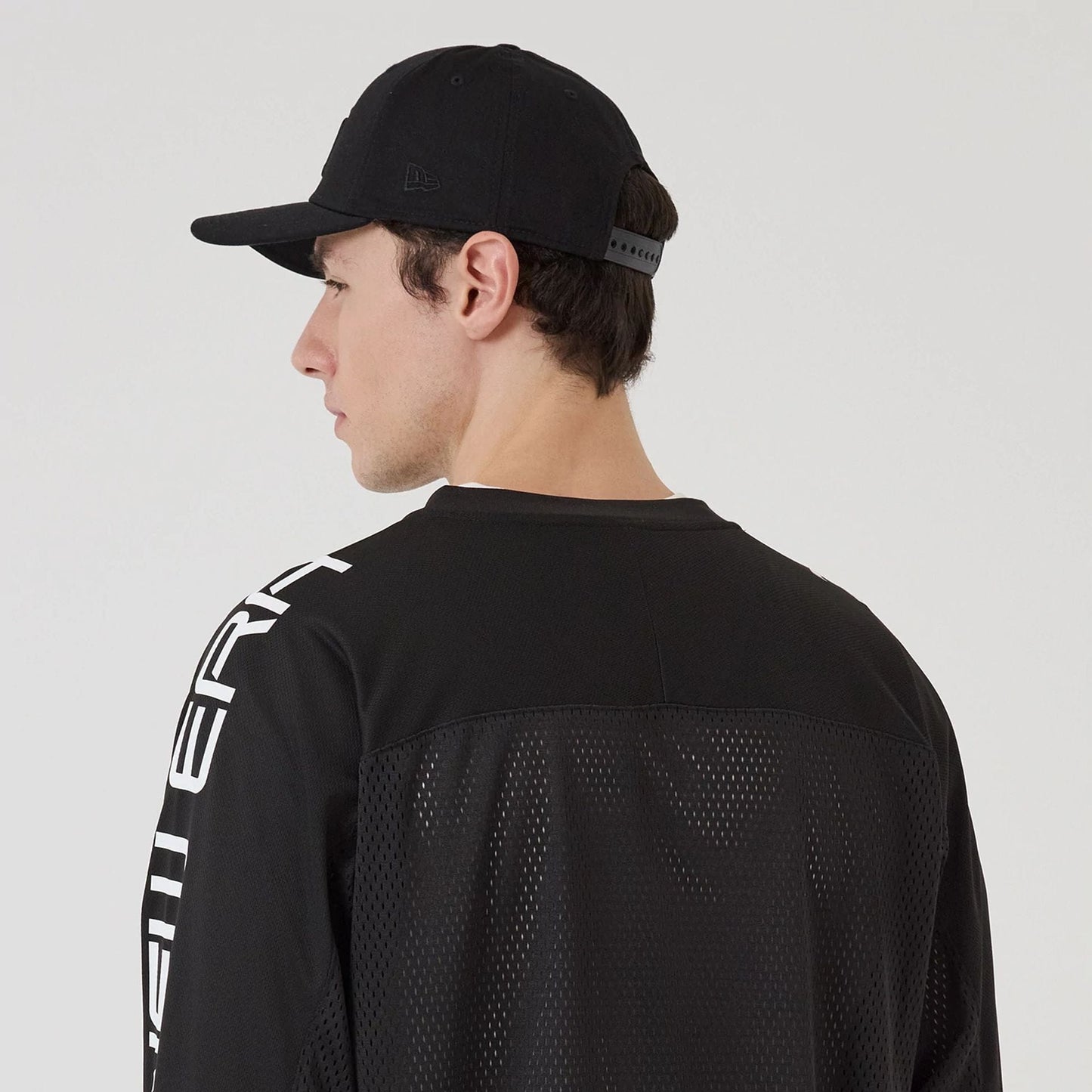 The model is wearing this New Era Urban Core Long Sleeve Jersey in black. 7