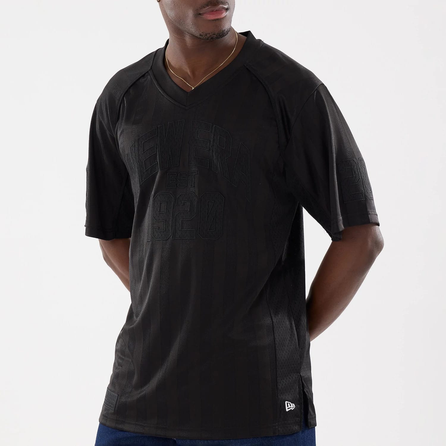 The model is wearing this New Era Street Archived Mesh Jersey in black. 3
