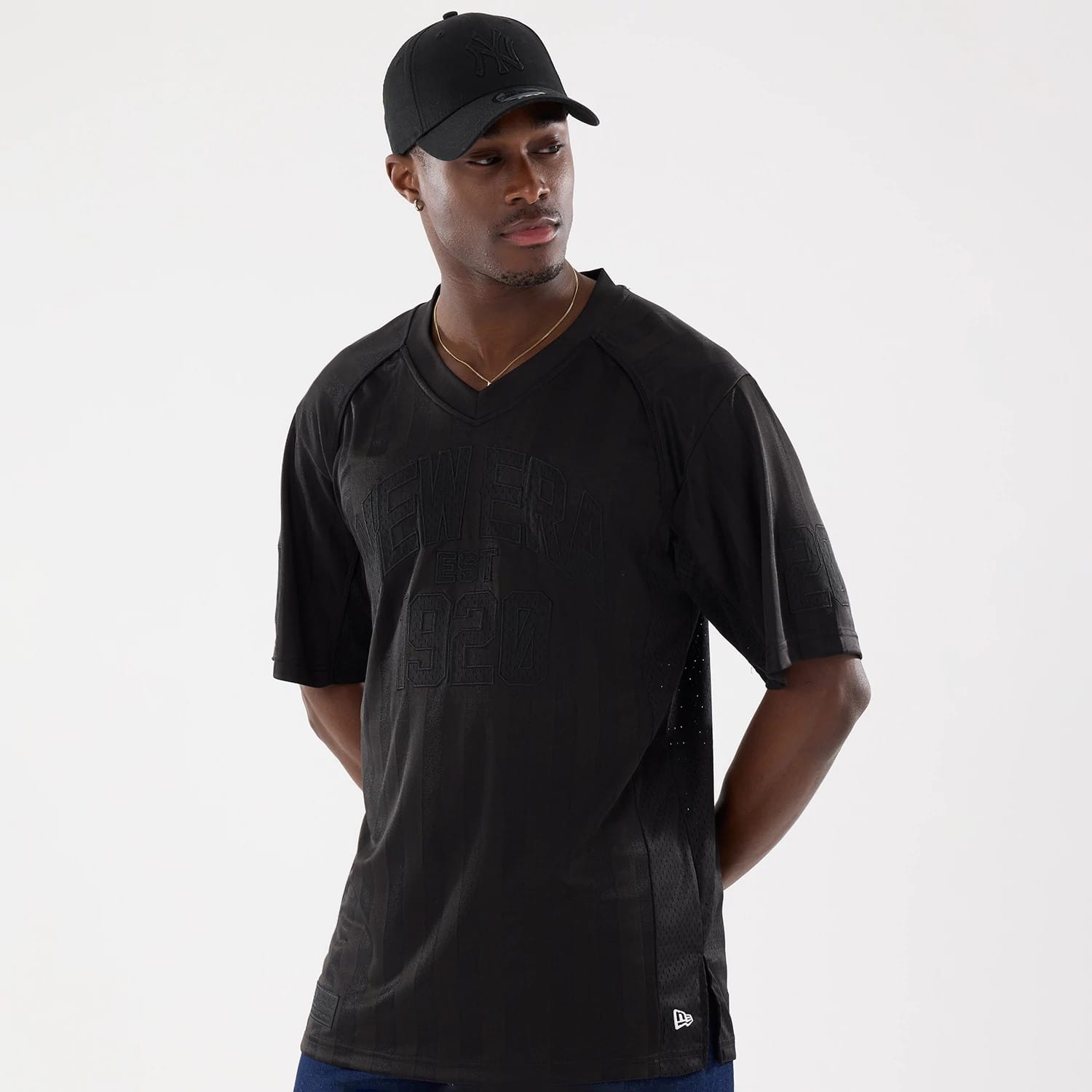 The model is wearing this New Era Street Archived Mesh Jersey in black. 1